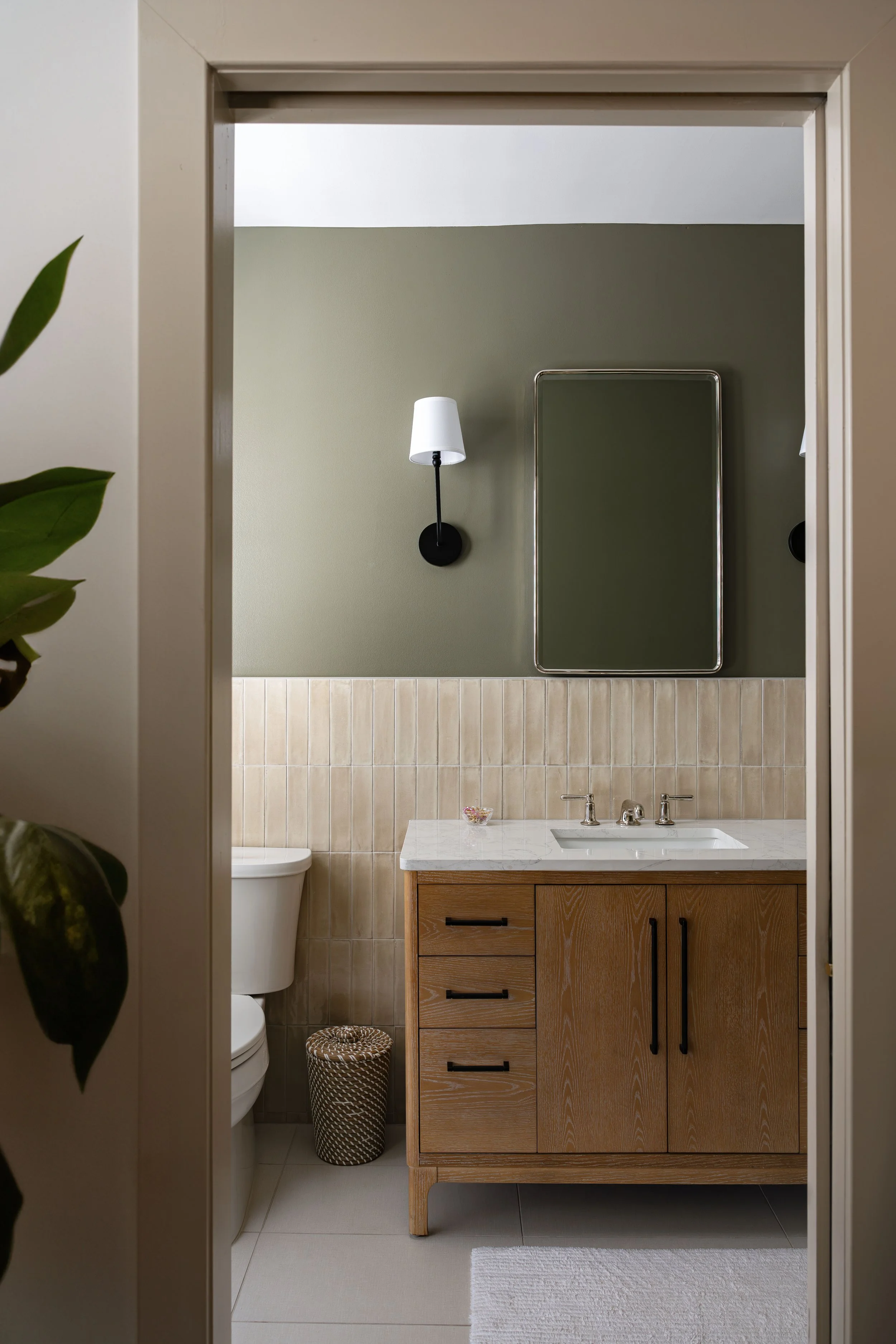 Primary bathroom renovation in a Washington, DC home with marble vanity, beige tiles, and chrome fixtures – Selis Studio Architecture.
