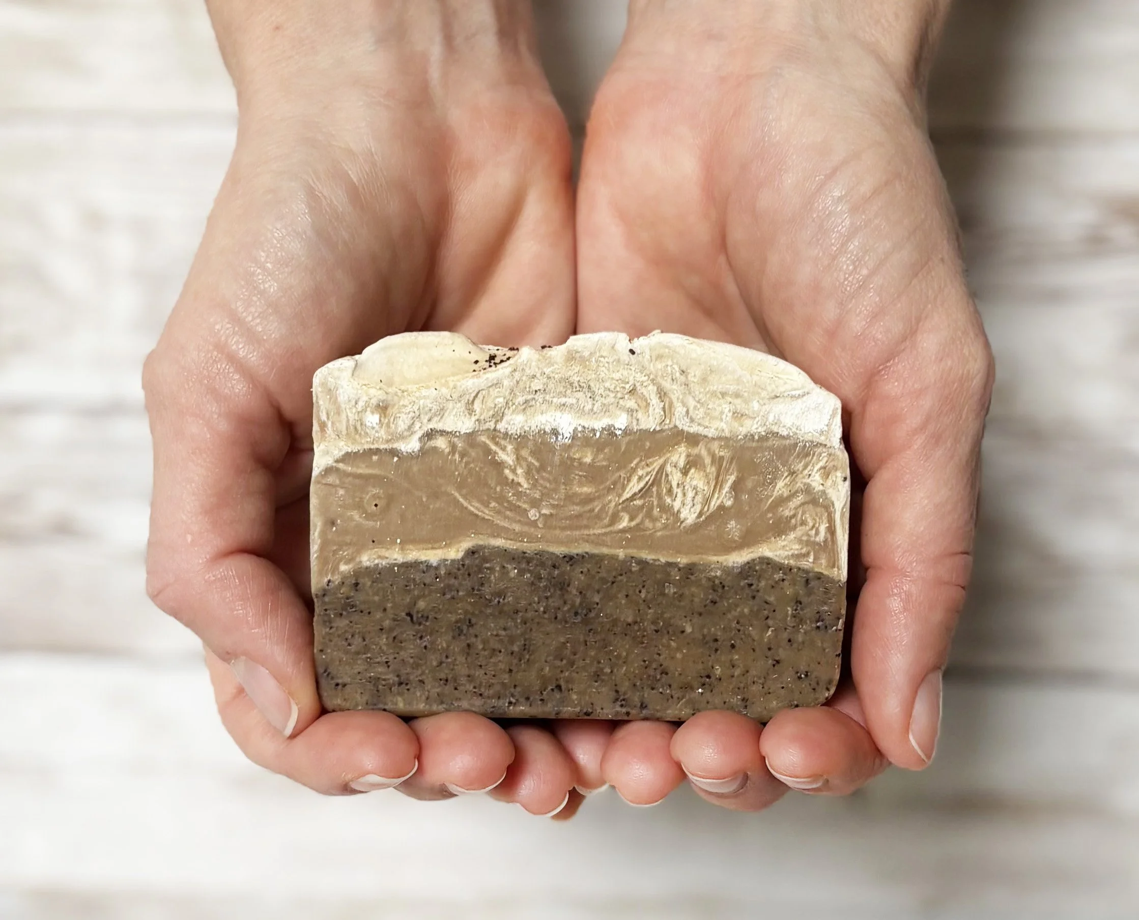 Coffee buttercream soap in hands.jpg