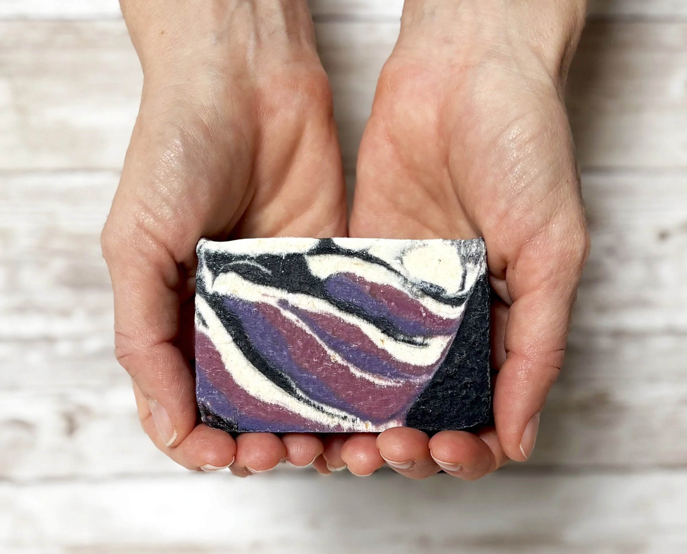 Black raspberry vanilla soap in hands.jpg
