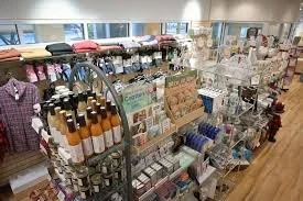 Display of various personal care and beauty products on a retail store shelf.