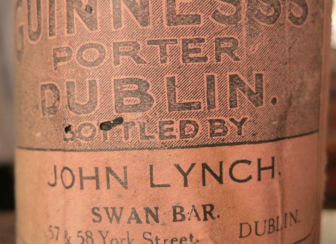 Close-up of a vintage label reading 'Oriental Porter Dublin' by John Lynch, Swan Bar, Dublin, with some wear and small holes.