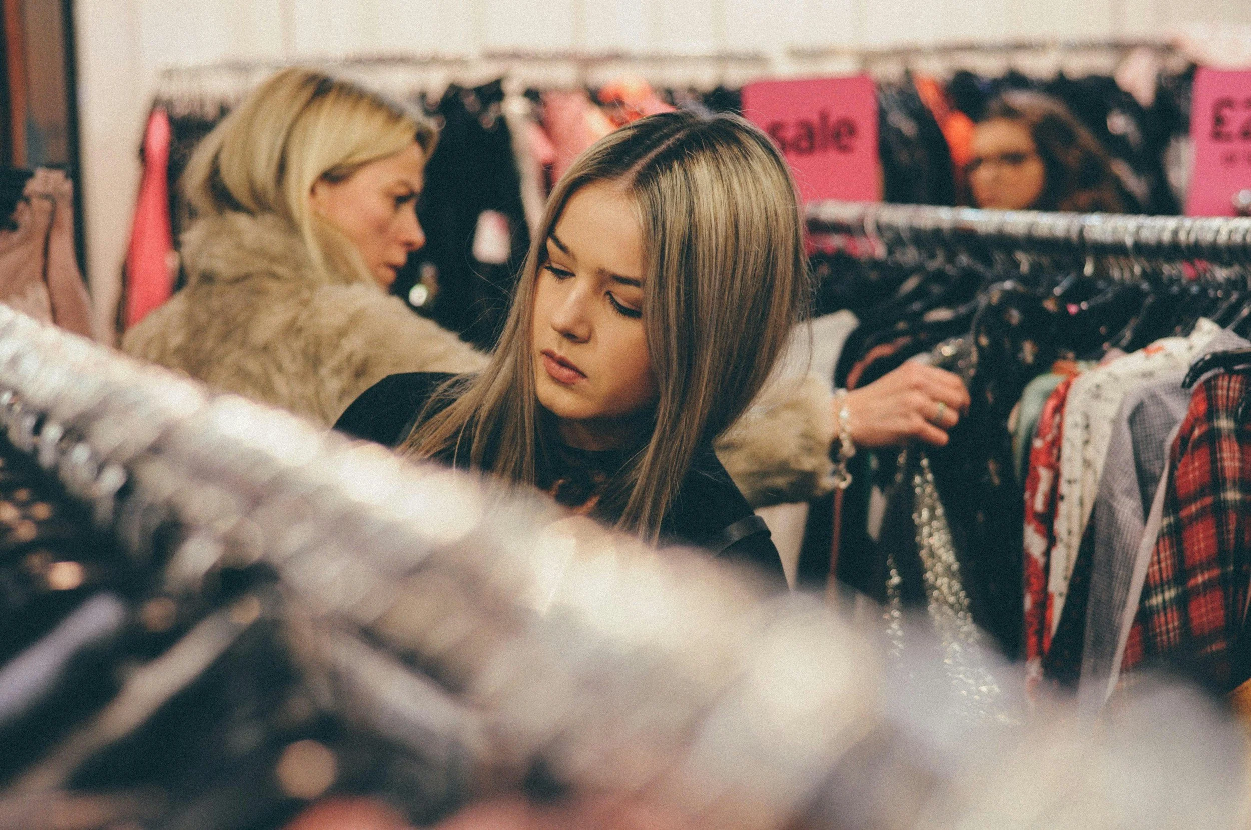 shoppers looking through sale racks