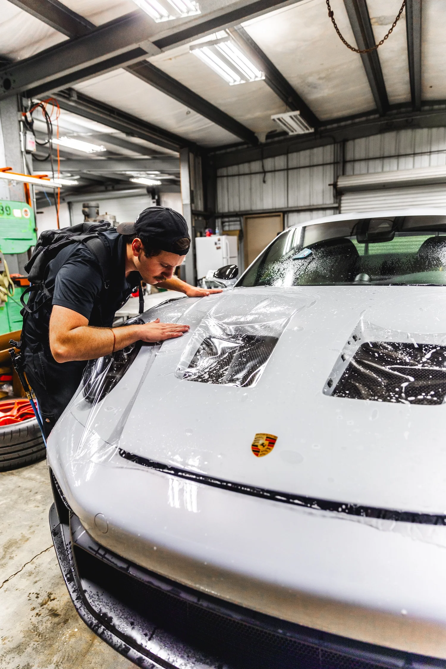 Paint protection film being installed on a Porsche in Chino, CA