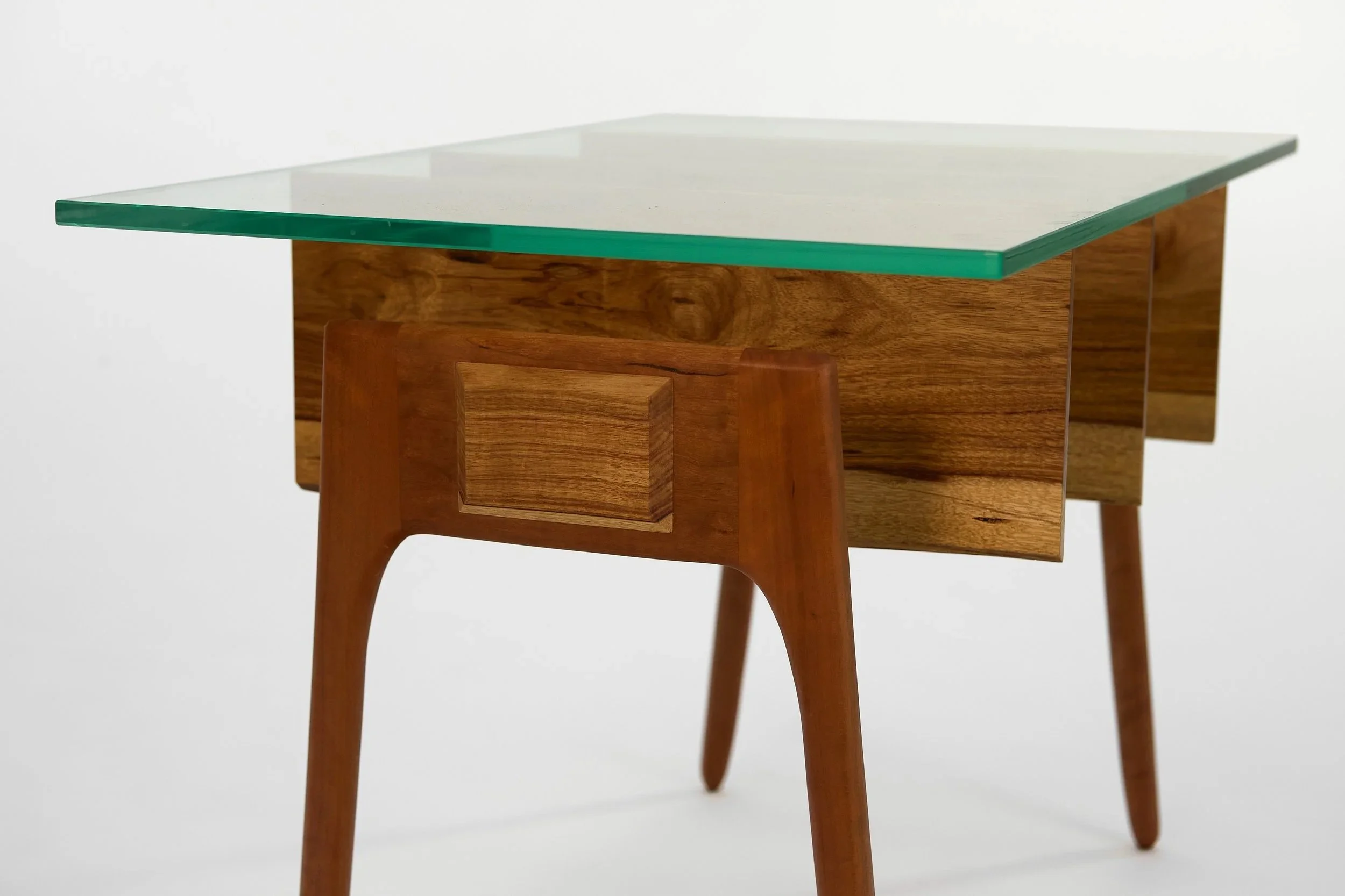      Rib table. Canarywood ribs, cherry legs. Stainless steel rods, glass.