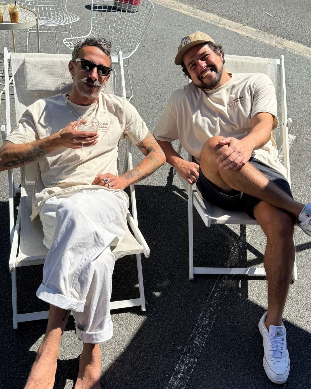 Two men relaxing on deck chairs at perk up byron The Roadhouse
