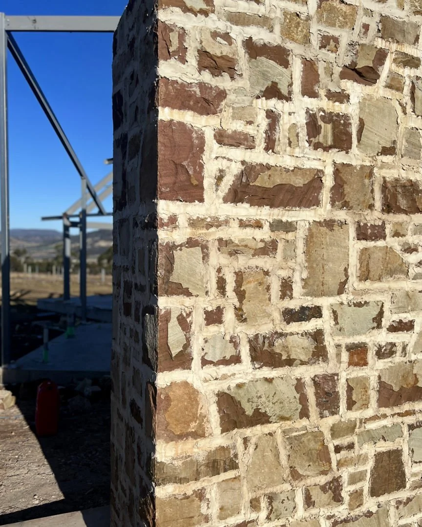 close up of stone edging mud brick with rough mortar style.