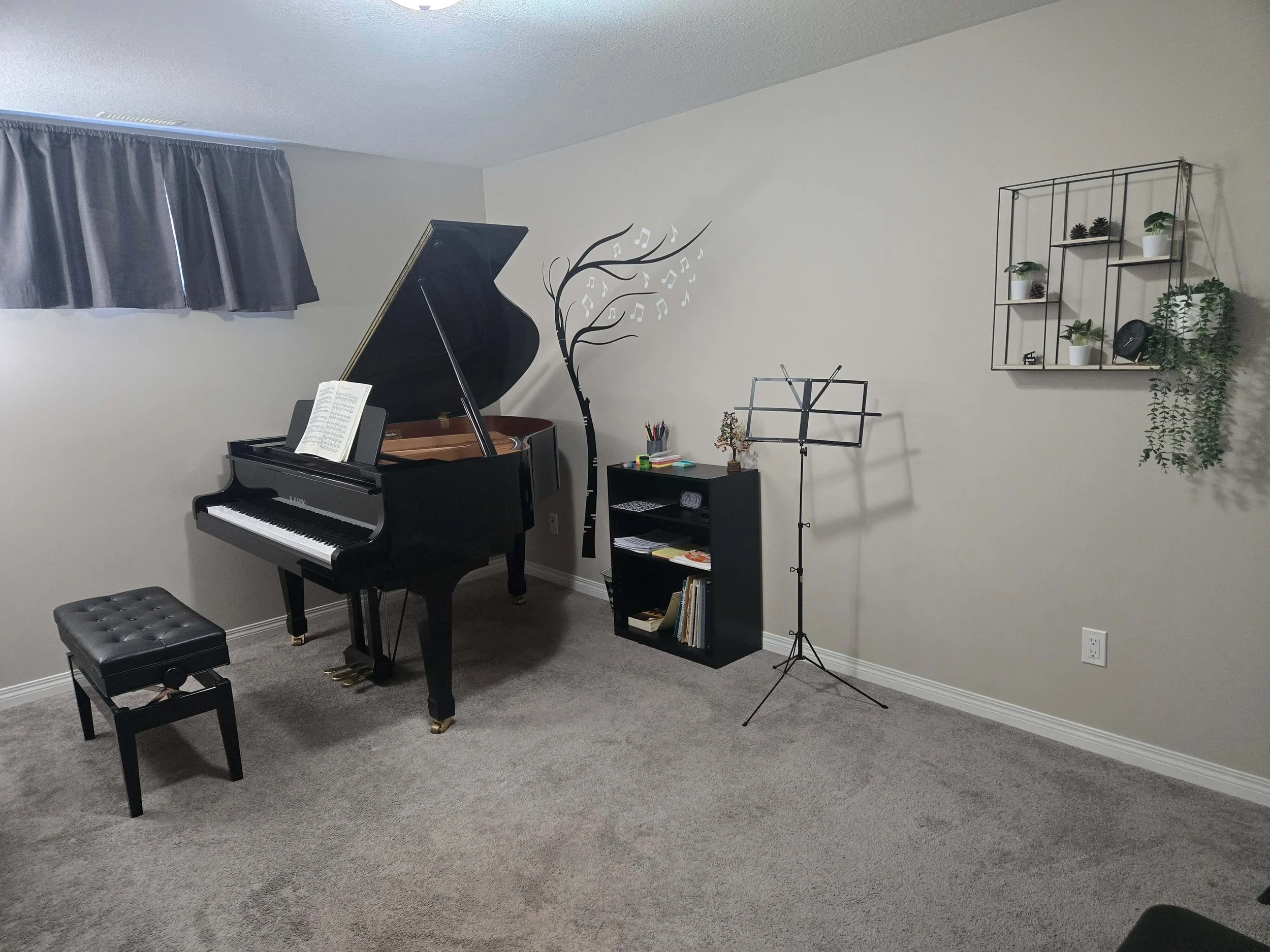 grand piano with a shelf next to it and a music stand