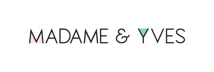 Logo with the text "Madame & Yves" in black, using stylized letters with pink and blue accents on the letters M and Y.