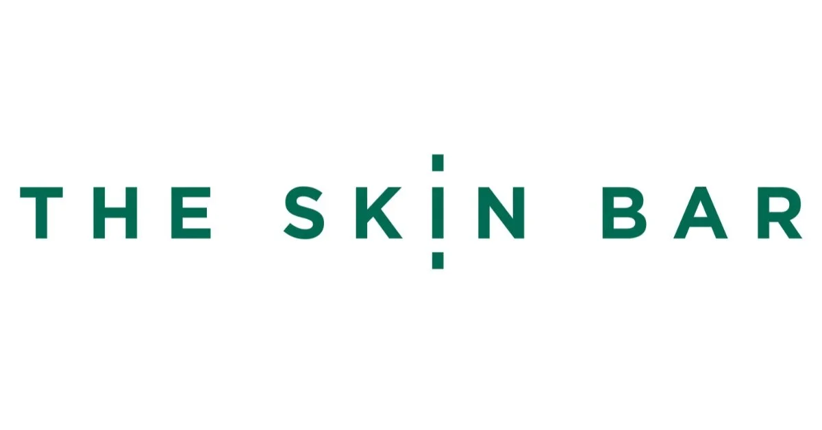 Logo for The Skin Bar with the name in green text on a white background.