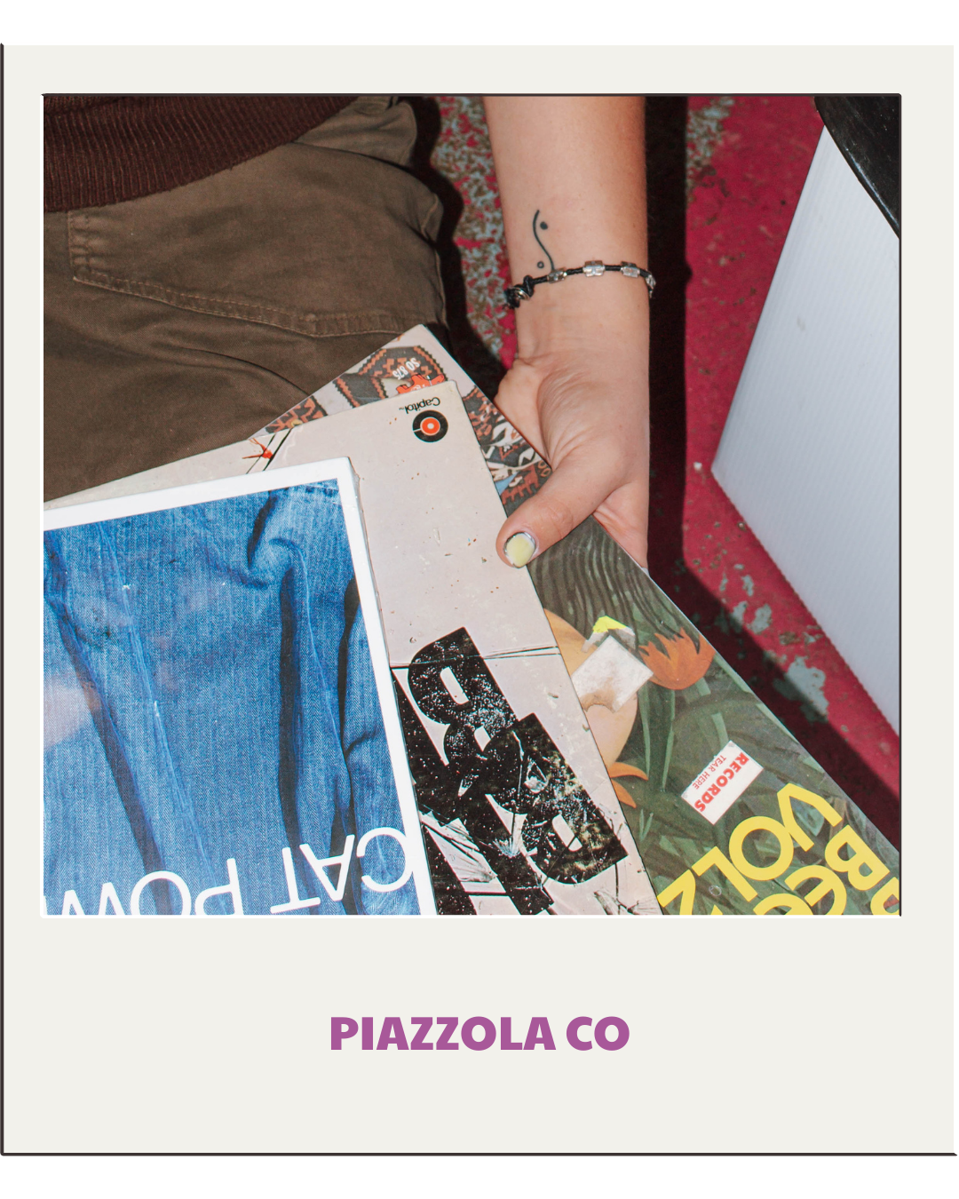 girl with painted nails holds vinyl records