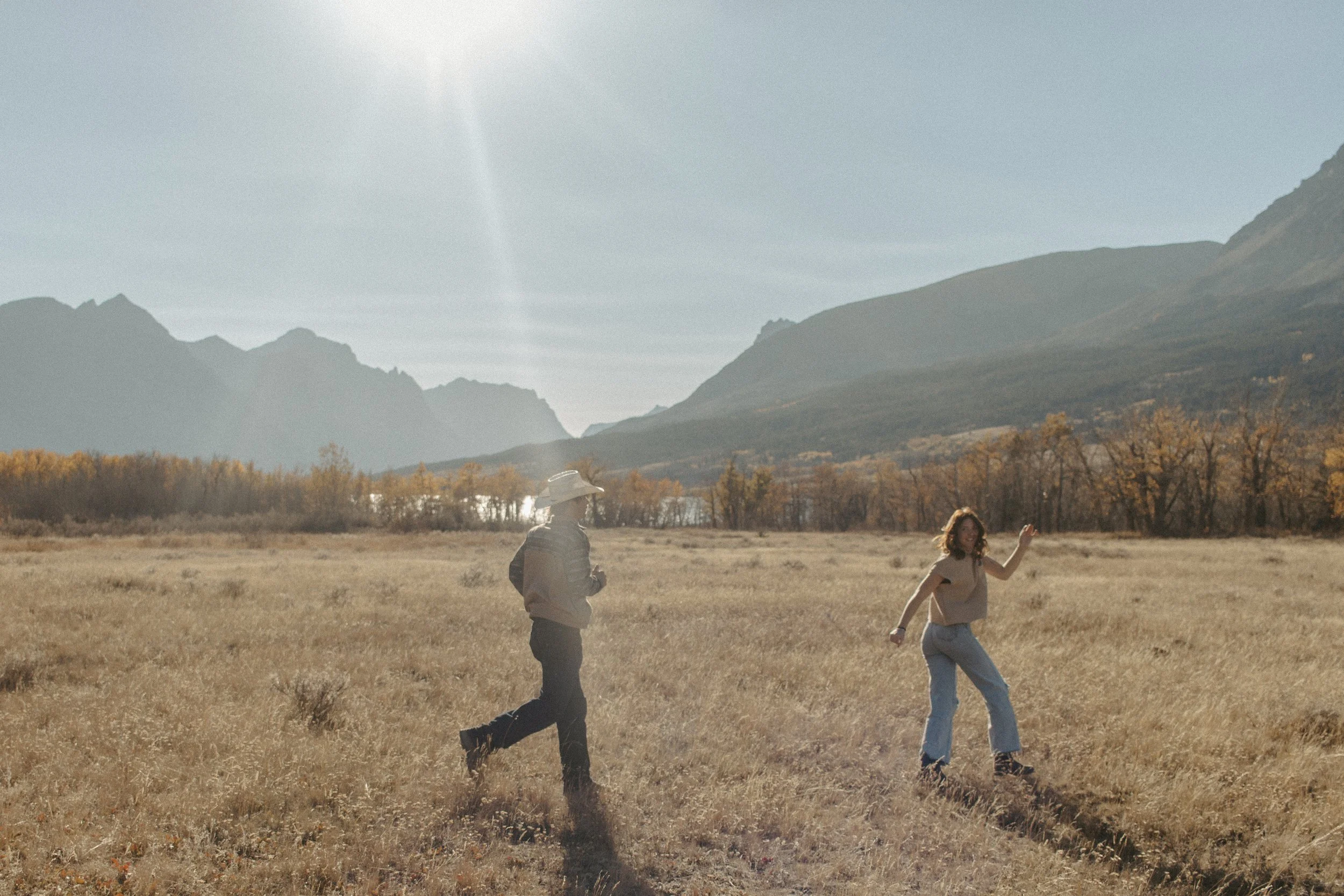couple runs around a field in fall