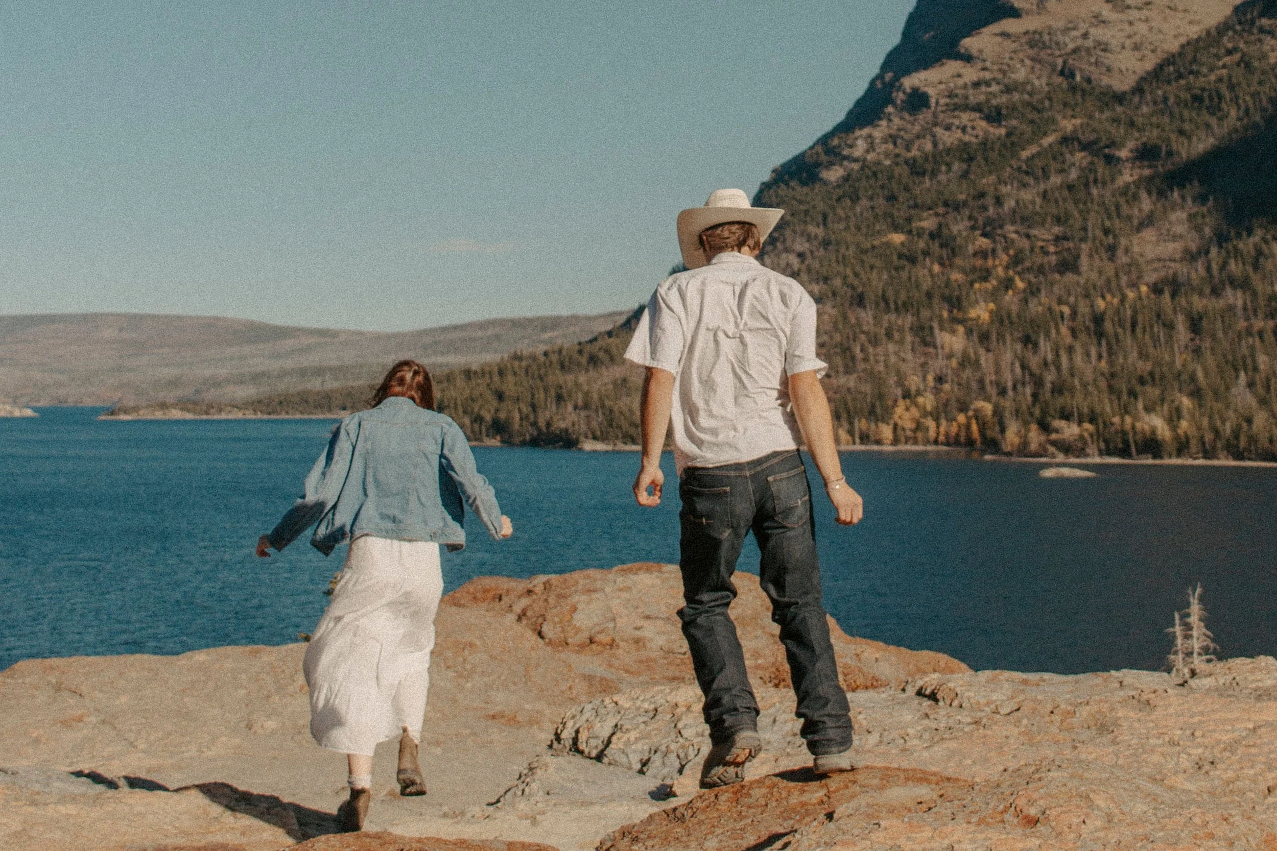 couple runs on rocks in front of lake