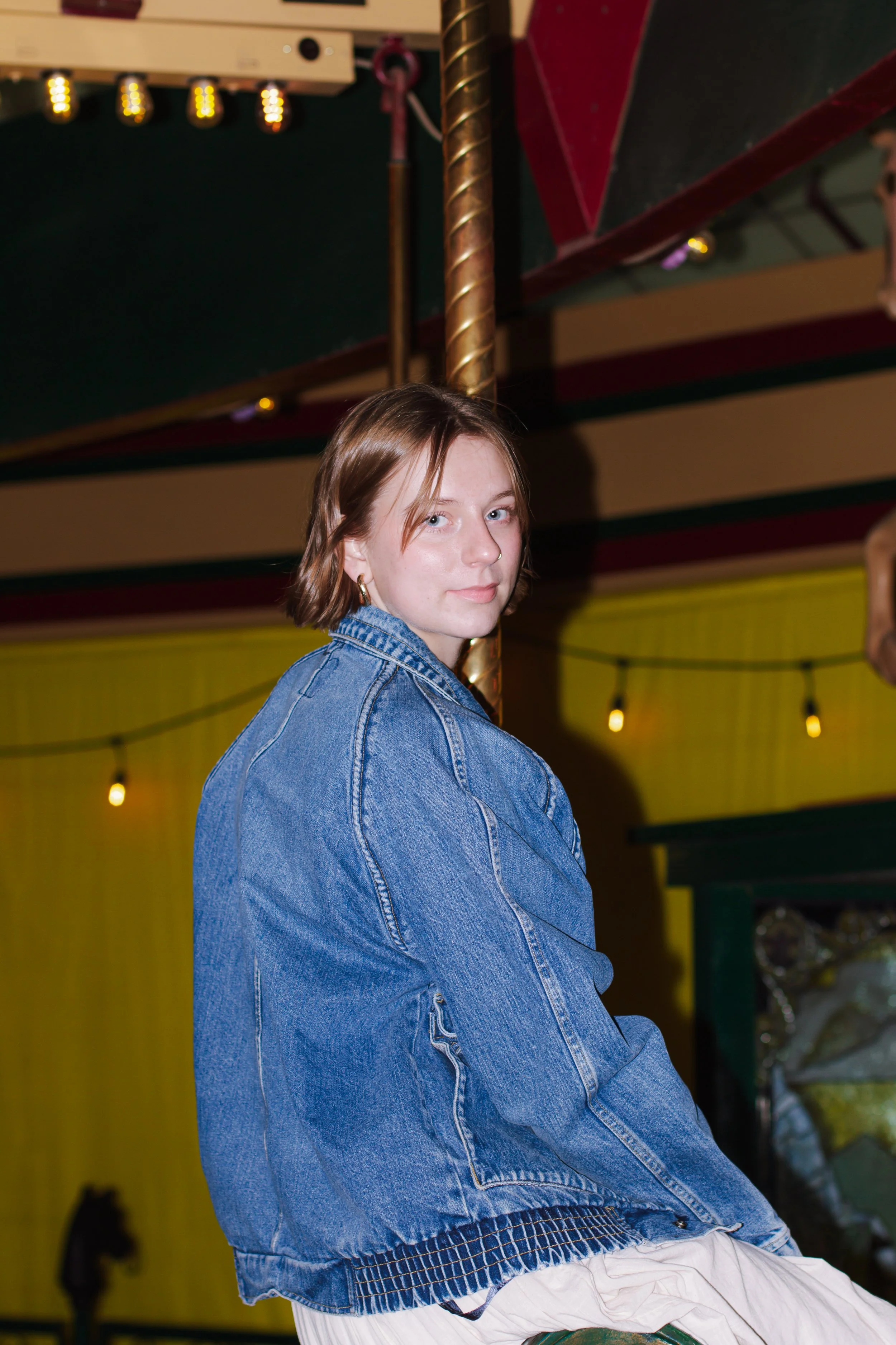 senior girl rides carousel