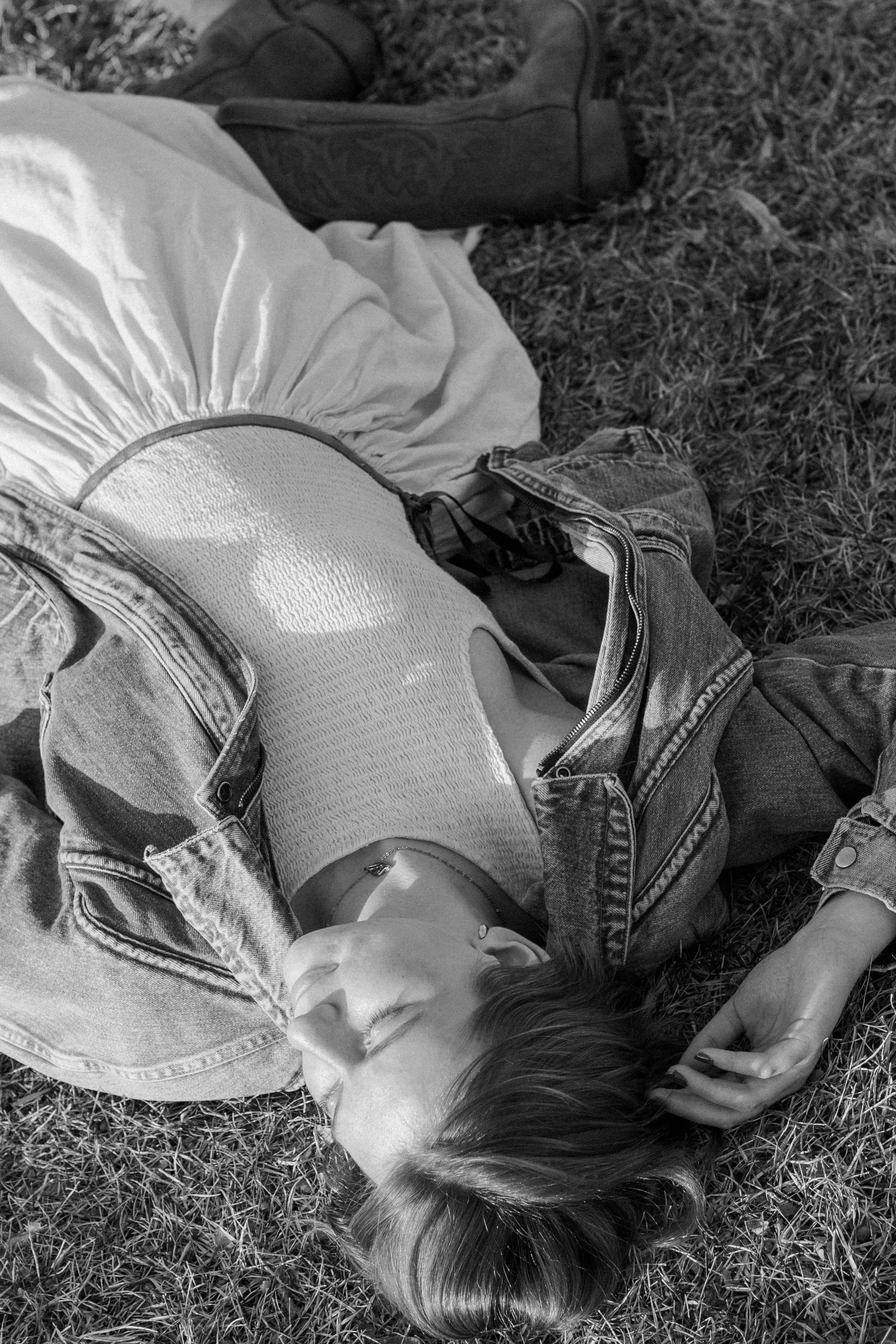 black and white photo of senior laying down in grass