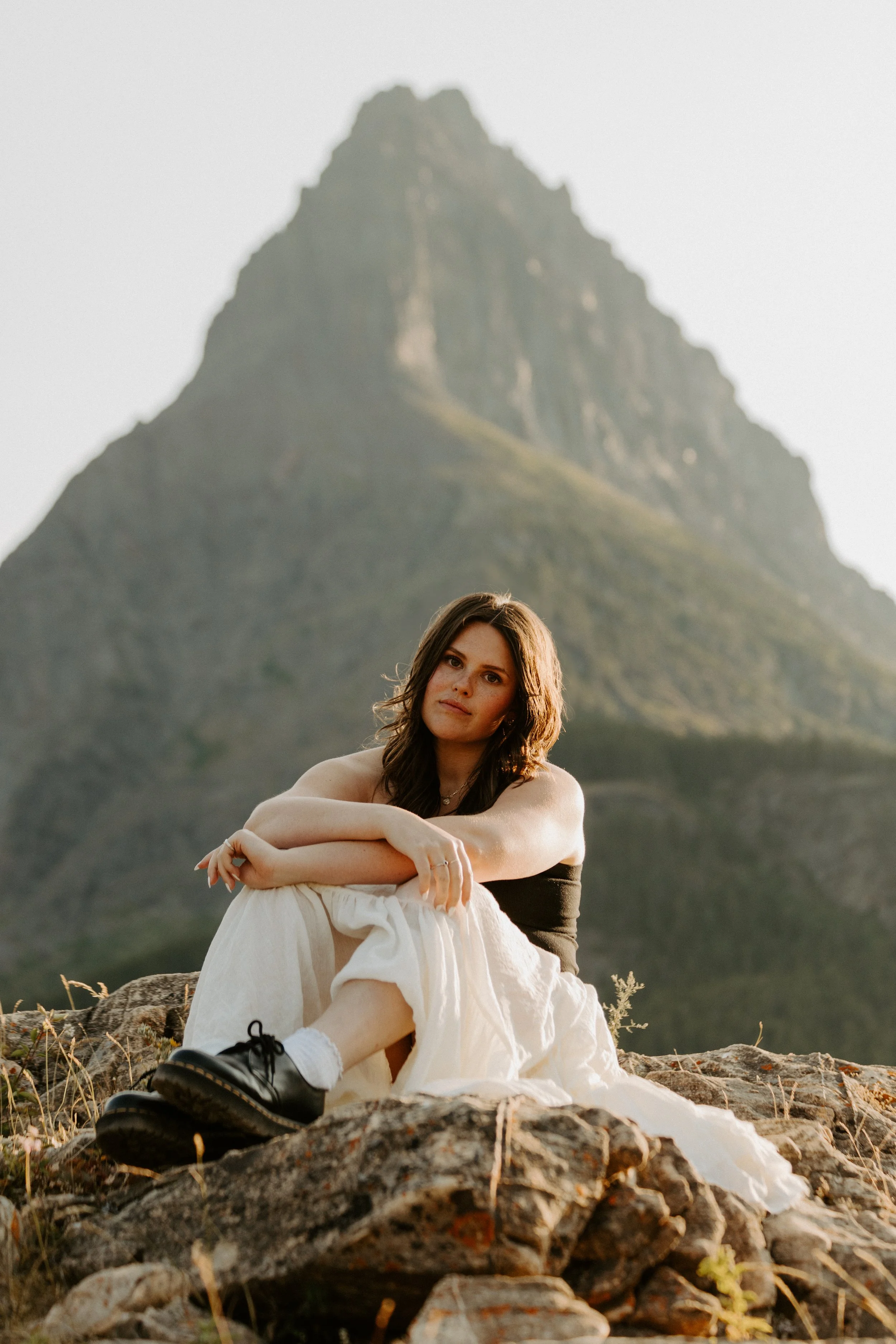 western montana photographer morgan sitting on a rock in many glacier