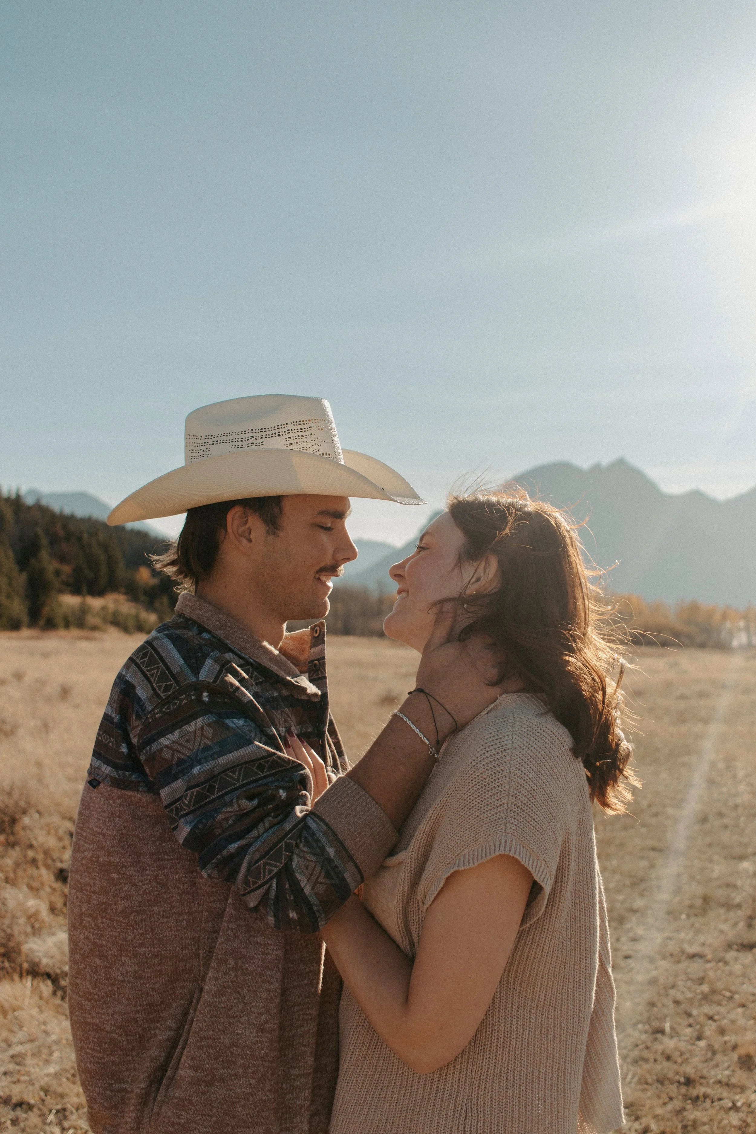 couple looks at each other while boy holds the girls face