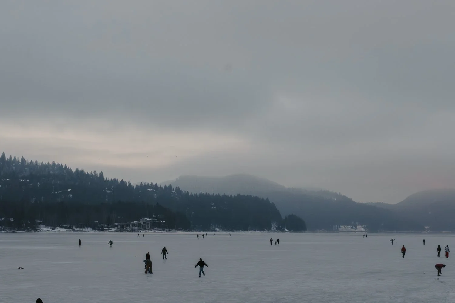 people ice skating on whitefish lake