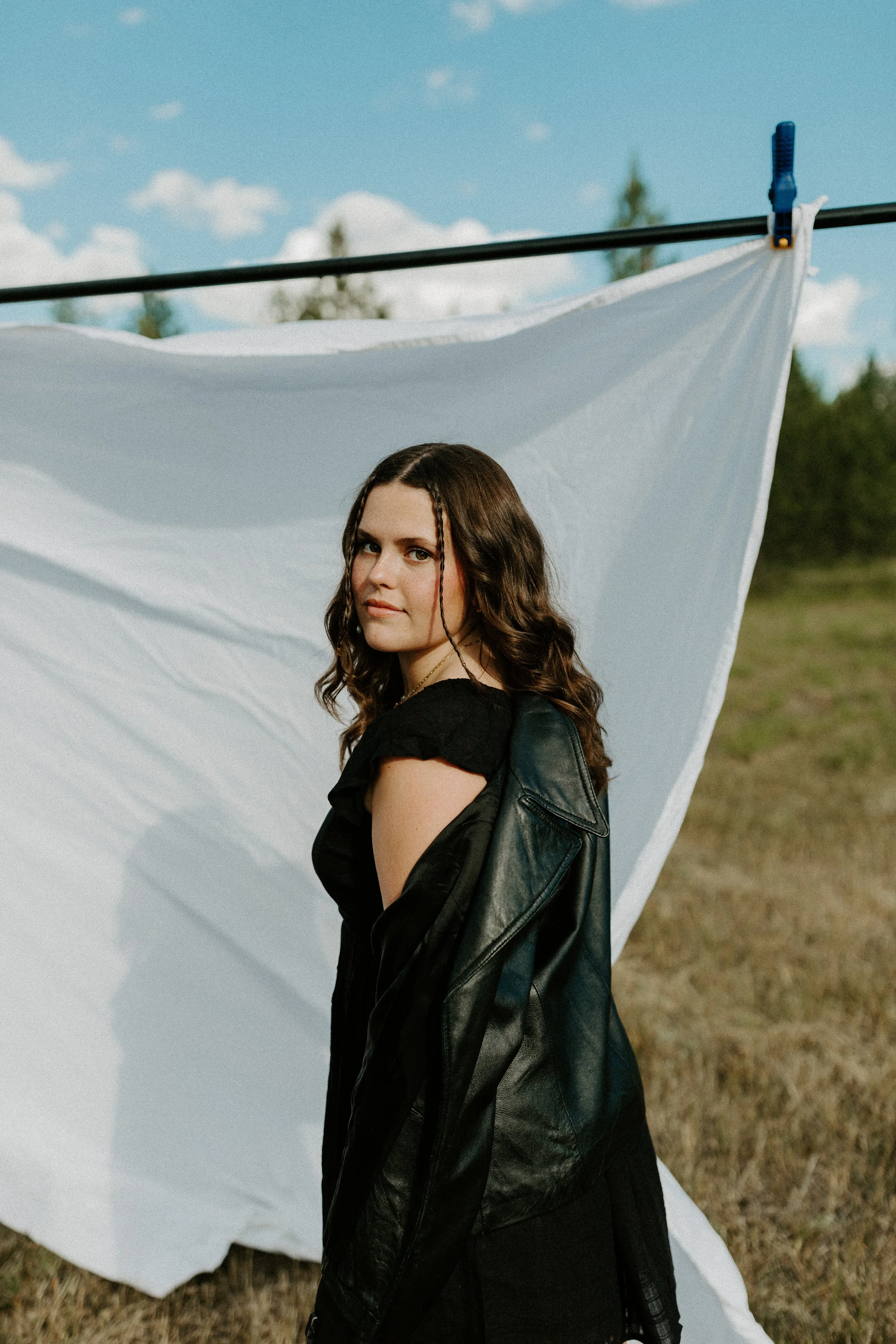 montana senior photographer morgan piazzola in front of white curtain