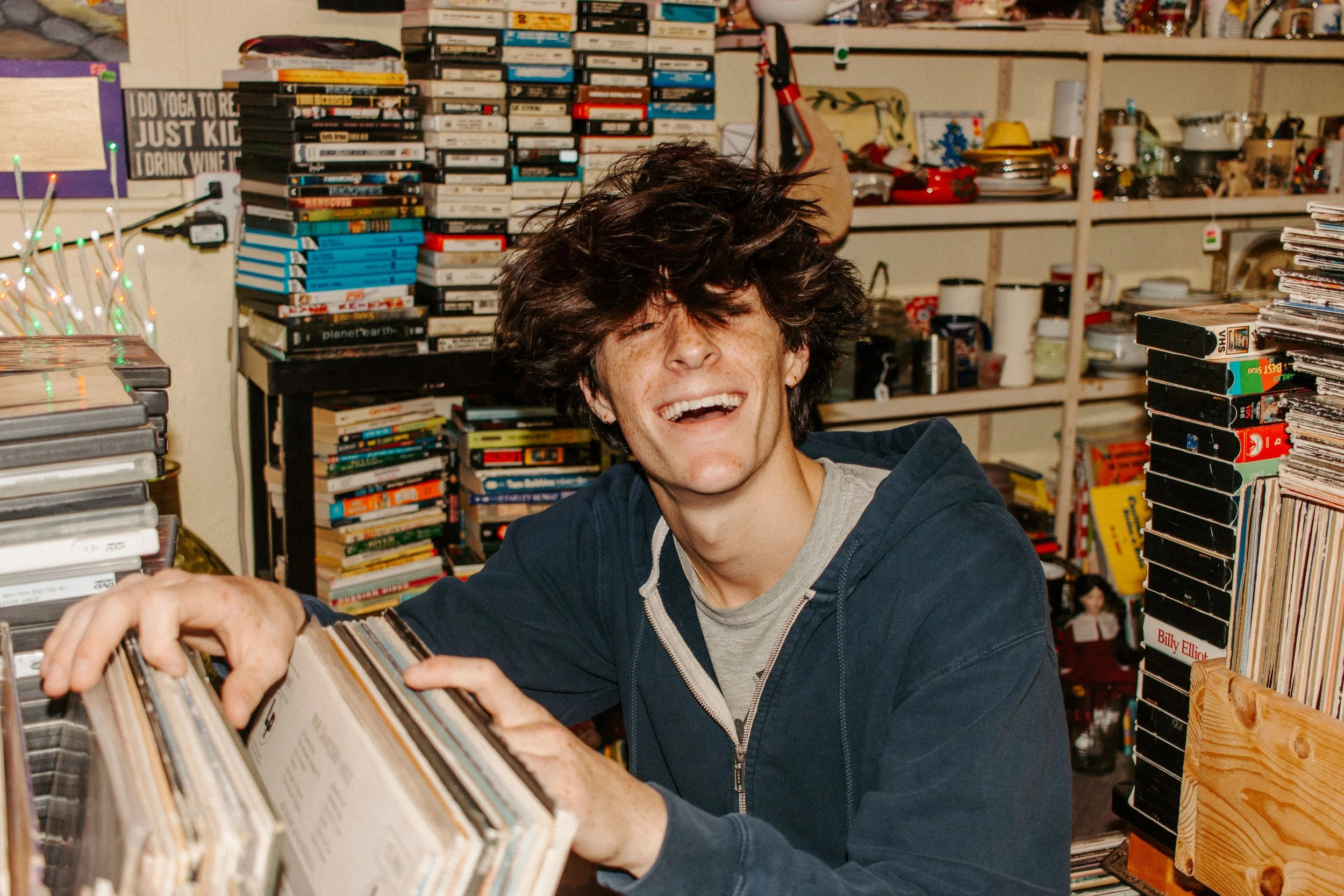 boy smiles while looking through records