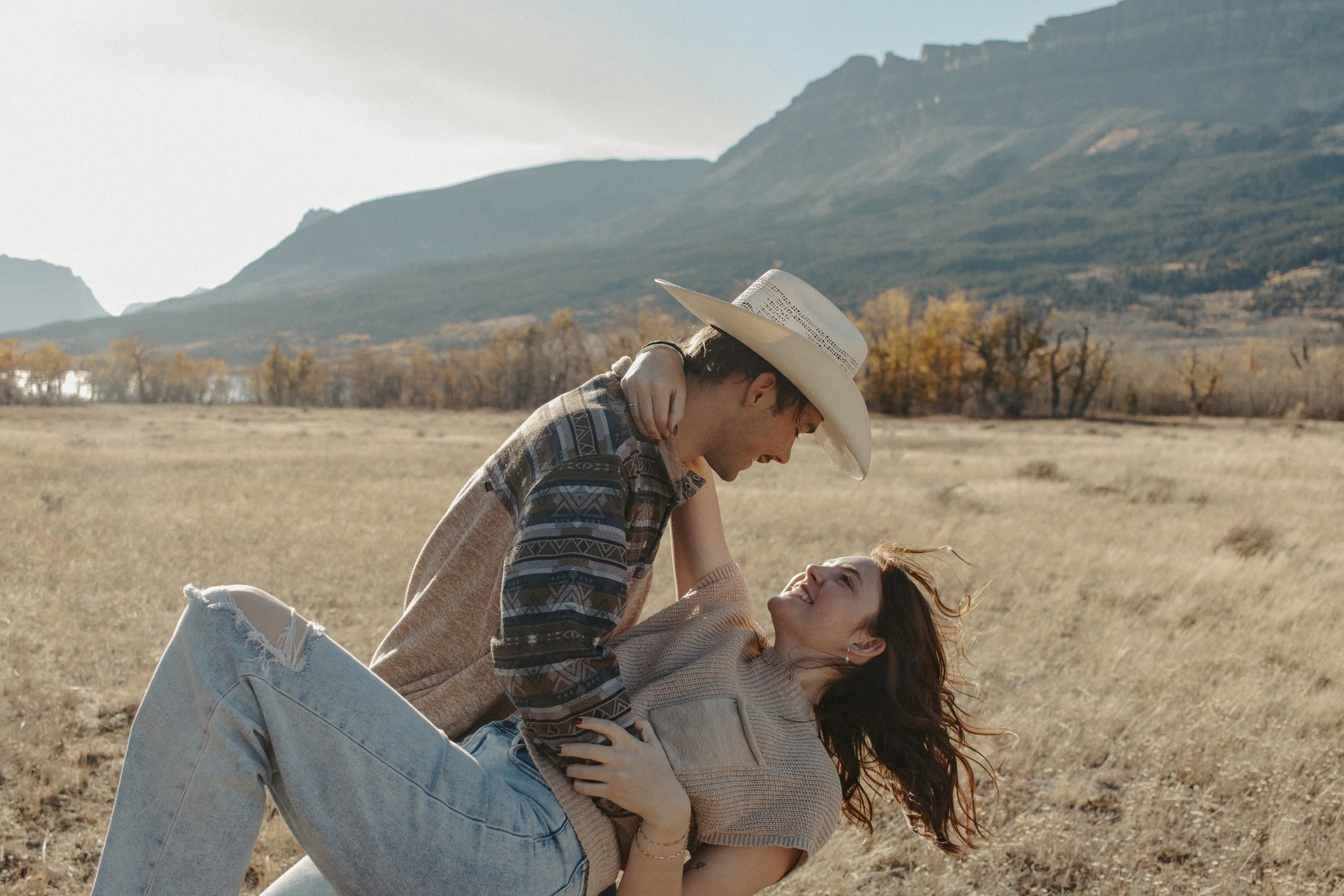 boy holds girl in field