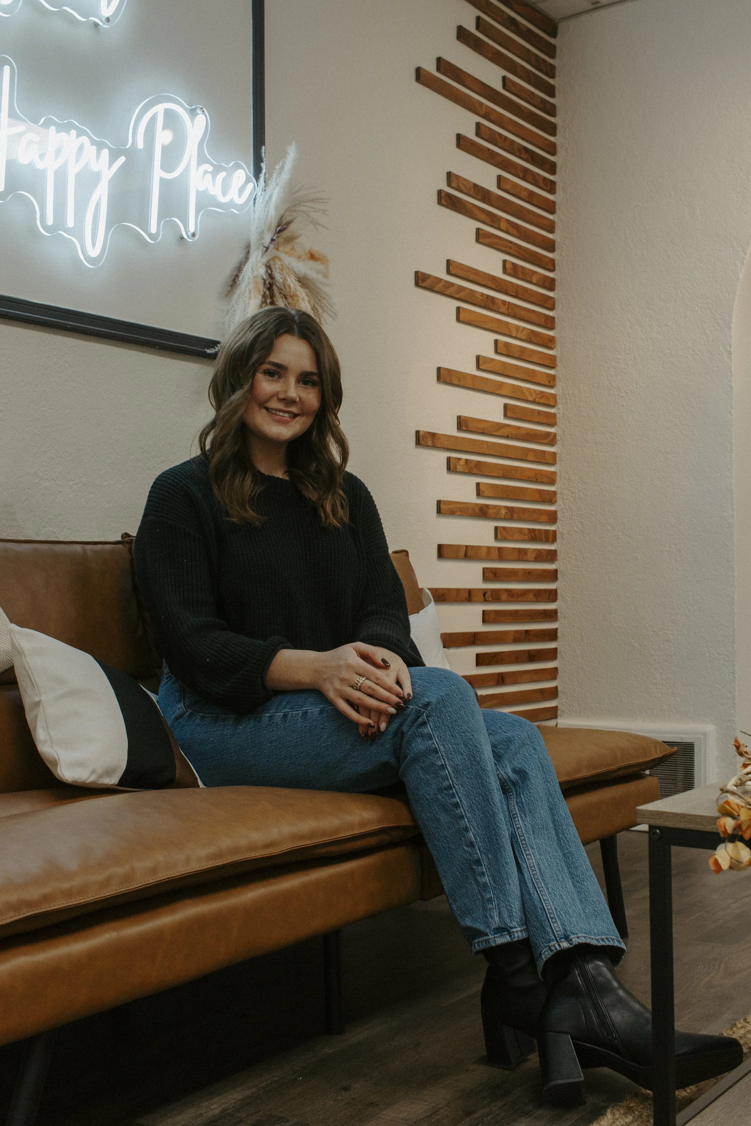 girl sits on couch while smiling