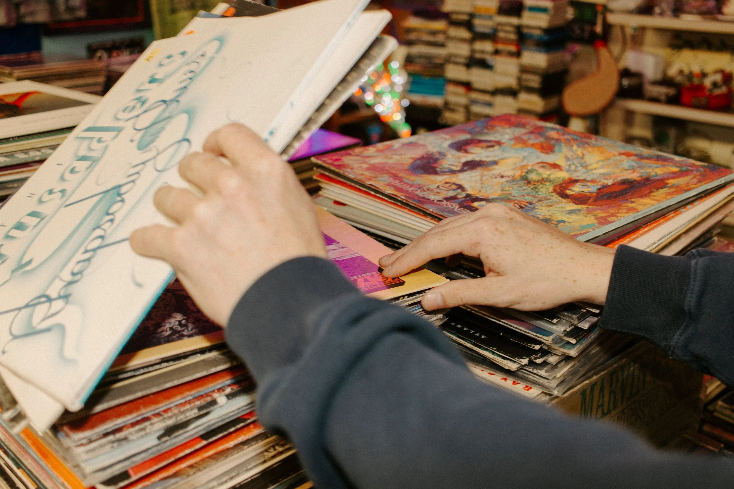 boys hands dig through vinyl records
