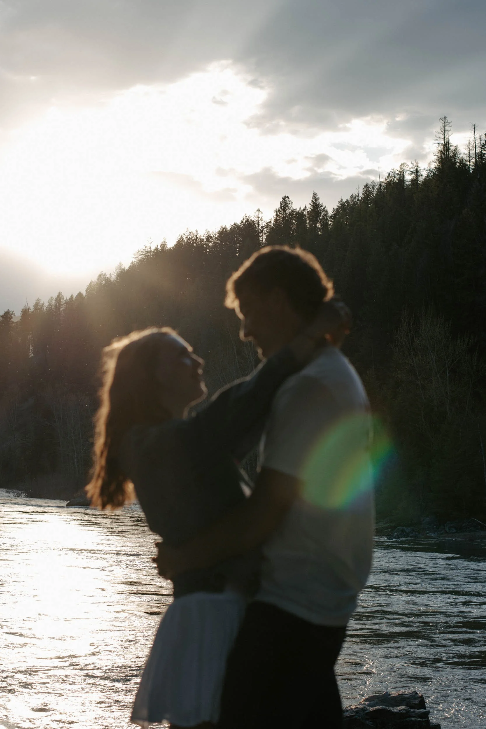 couple dancing in front of glacier river