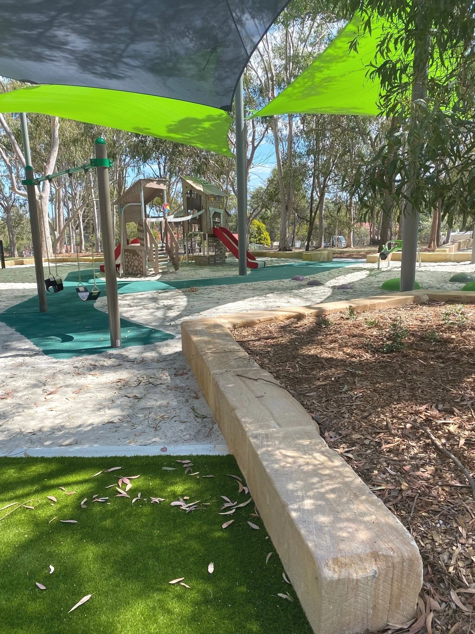 Natural play elements and timber balancing logs in the playground at Hanover Drive Park

