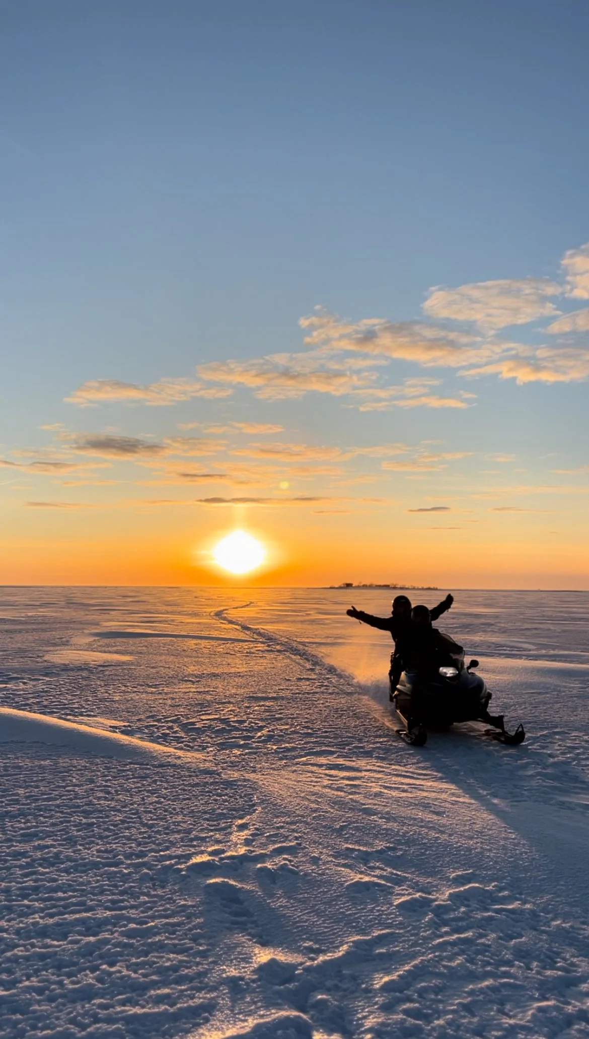Private Snowmobile Tours in Lapland. Snowmobile on frozen sea.