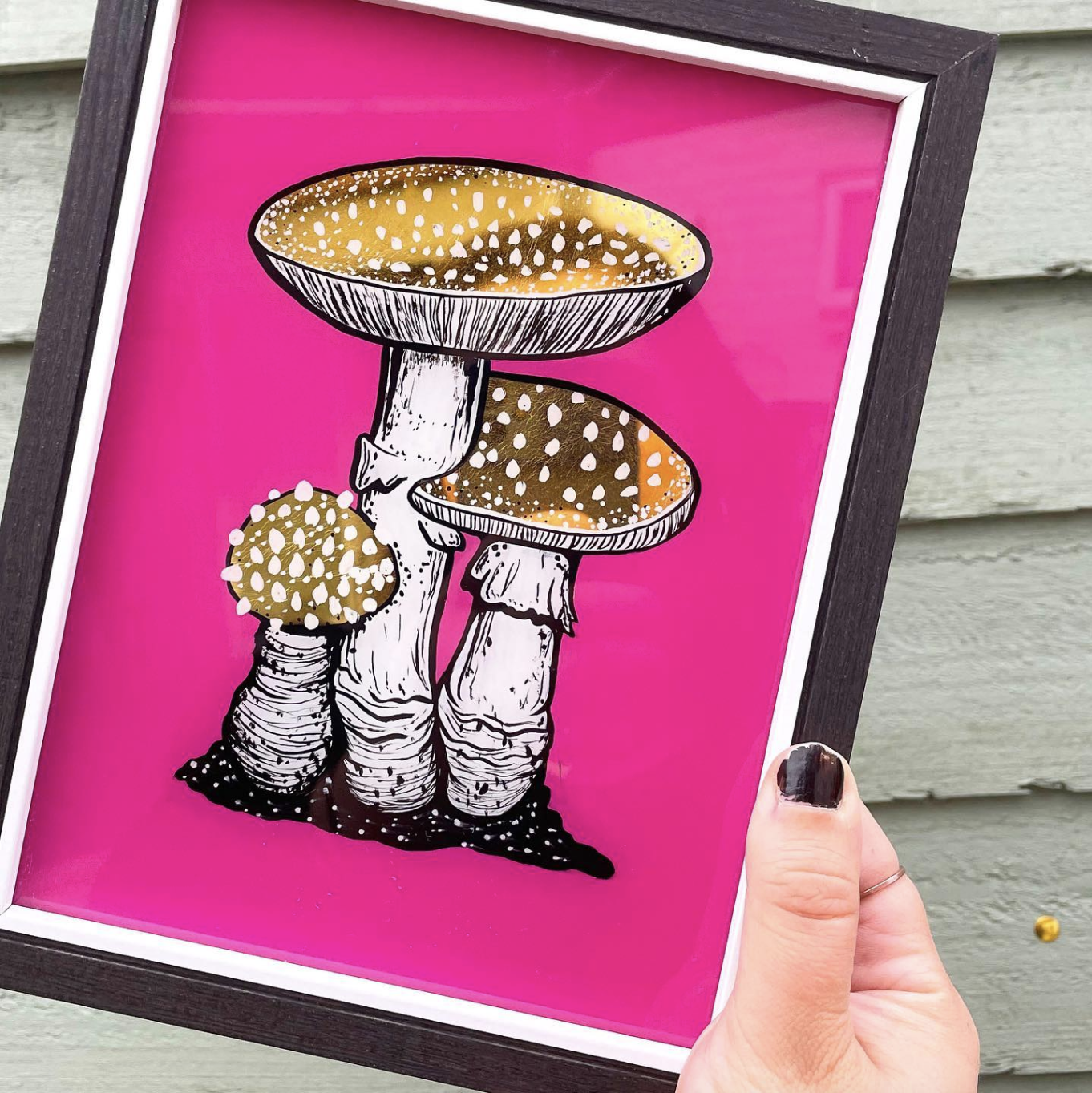 Artwork of four mushrooms with yellow caps and black and white stems, set against a bright pink background.