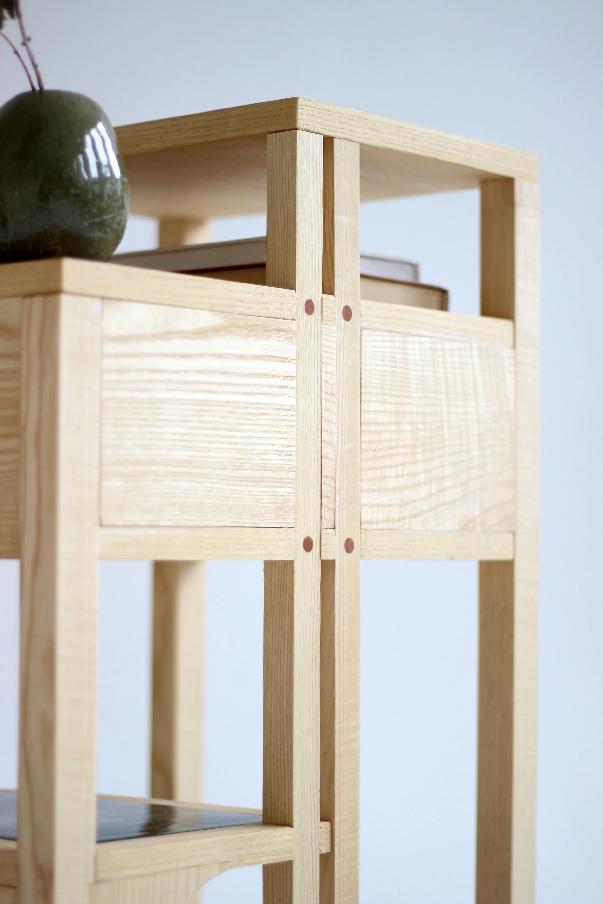 A wooden nightstand design with ceramic detailed