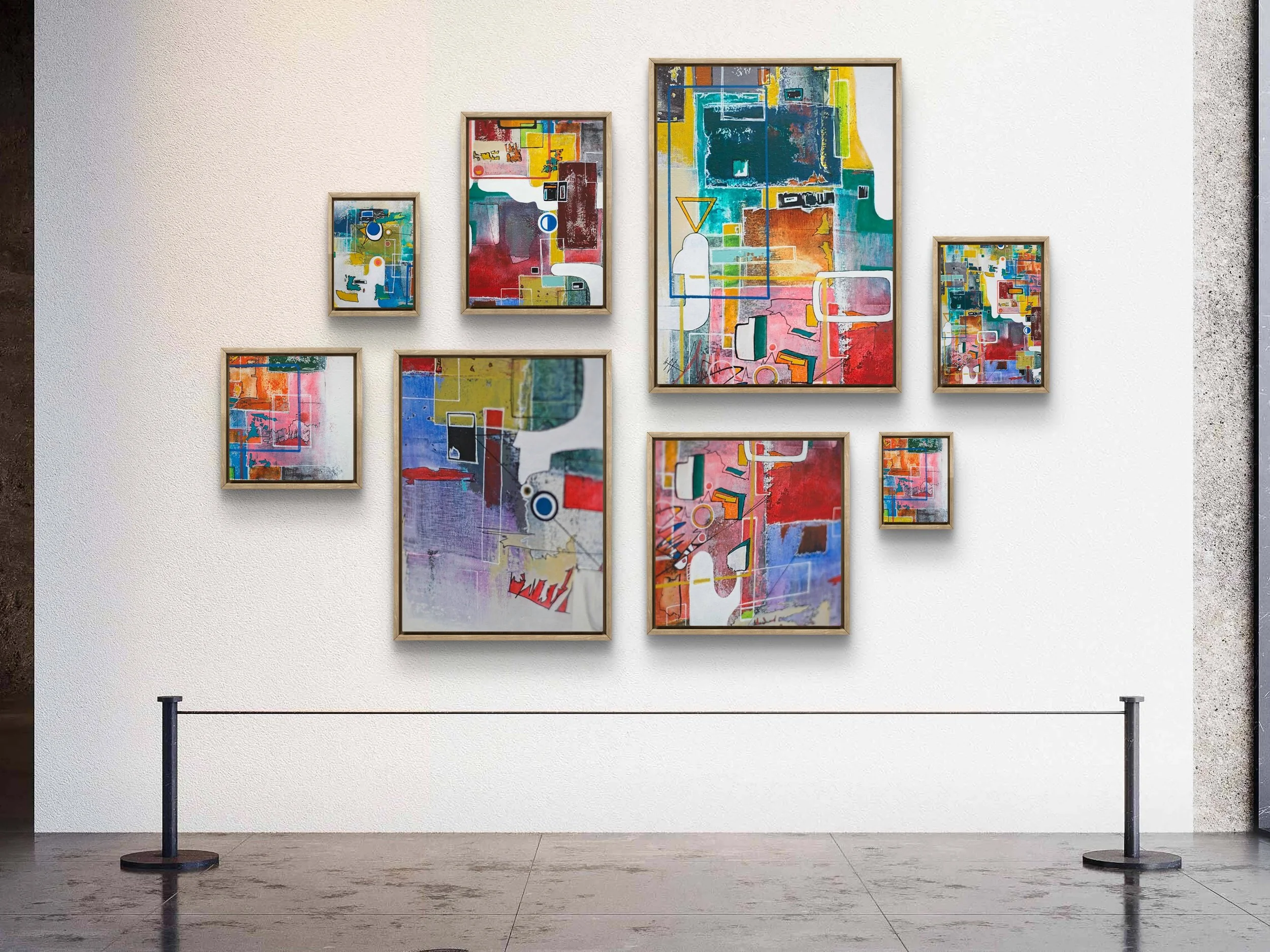 Modern abstract artwork consisting of seven colorful paintings displayed on a white wall in a gallery setting.