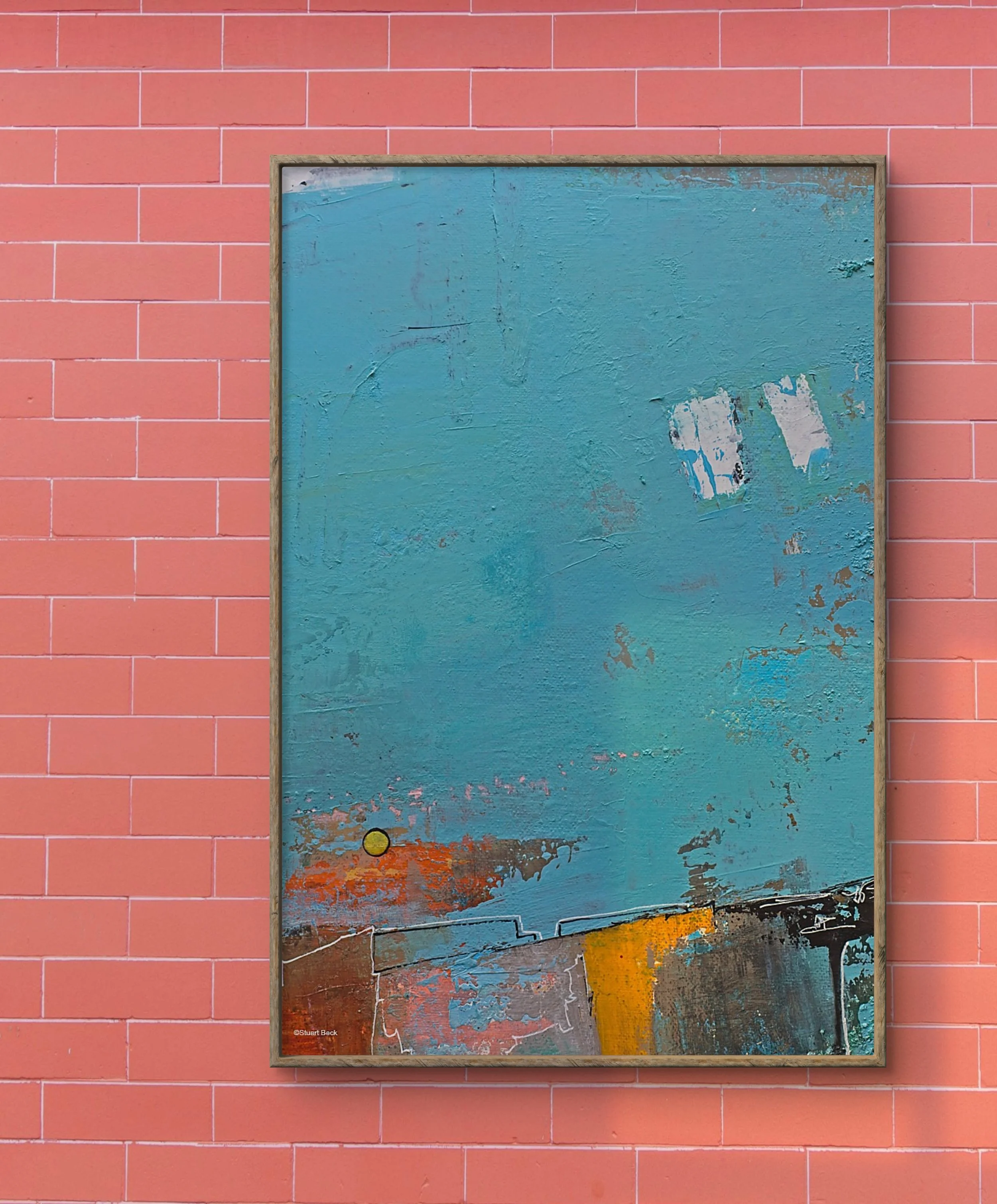 Abstract painting with blue, orange, yellow, and black colors, framed and hung on a pink brick wall.