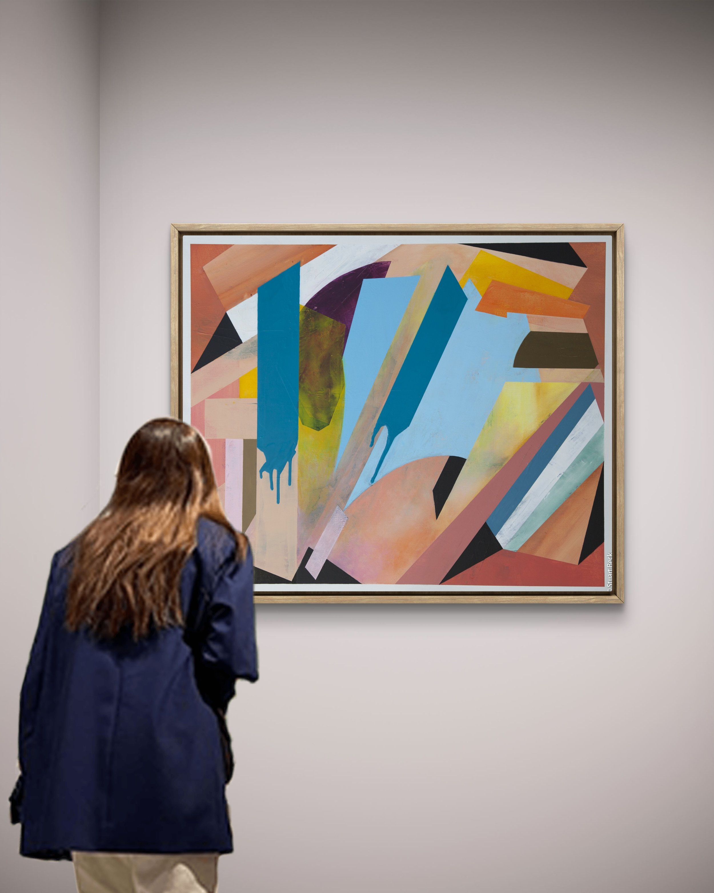 A woman with brown hair wearing a dark blue jacket and beige pants looking at an abstract painting in an art gallery.