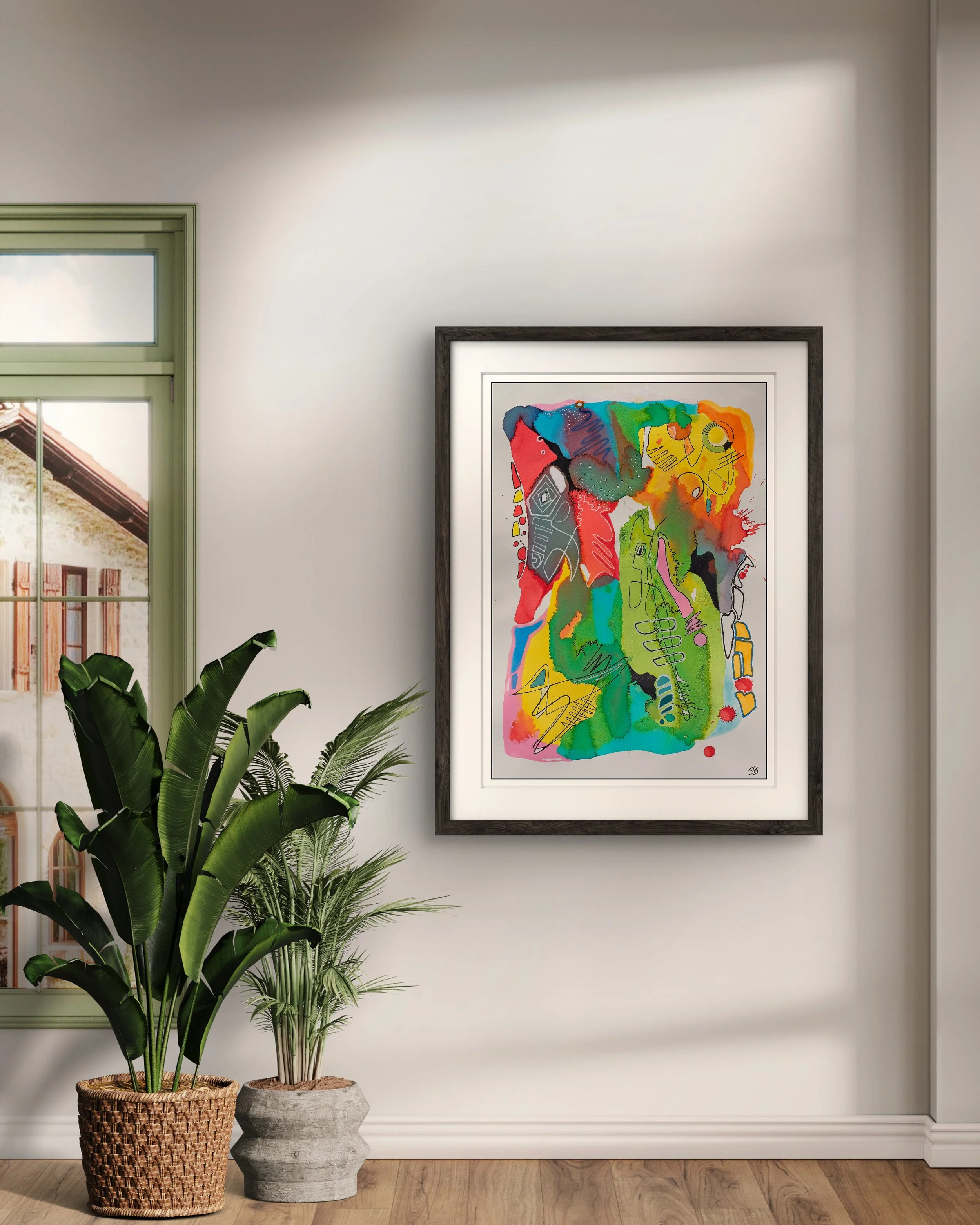 A colorful abstract painting in a black frame hangs on a white wall. There are two potted plants, one with broad green leaves and the other with thinner, palm-like leaves, placed on the wooden floor below the painting. A window with a partial view of