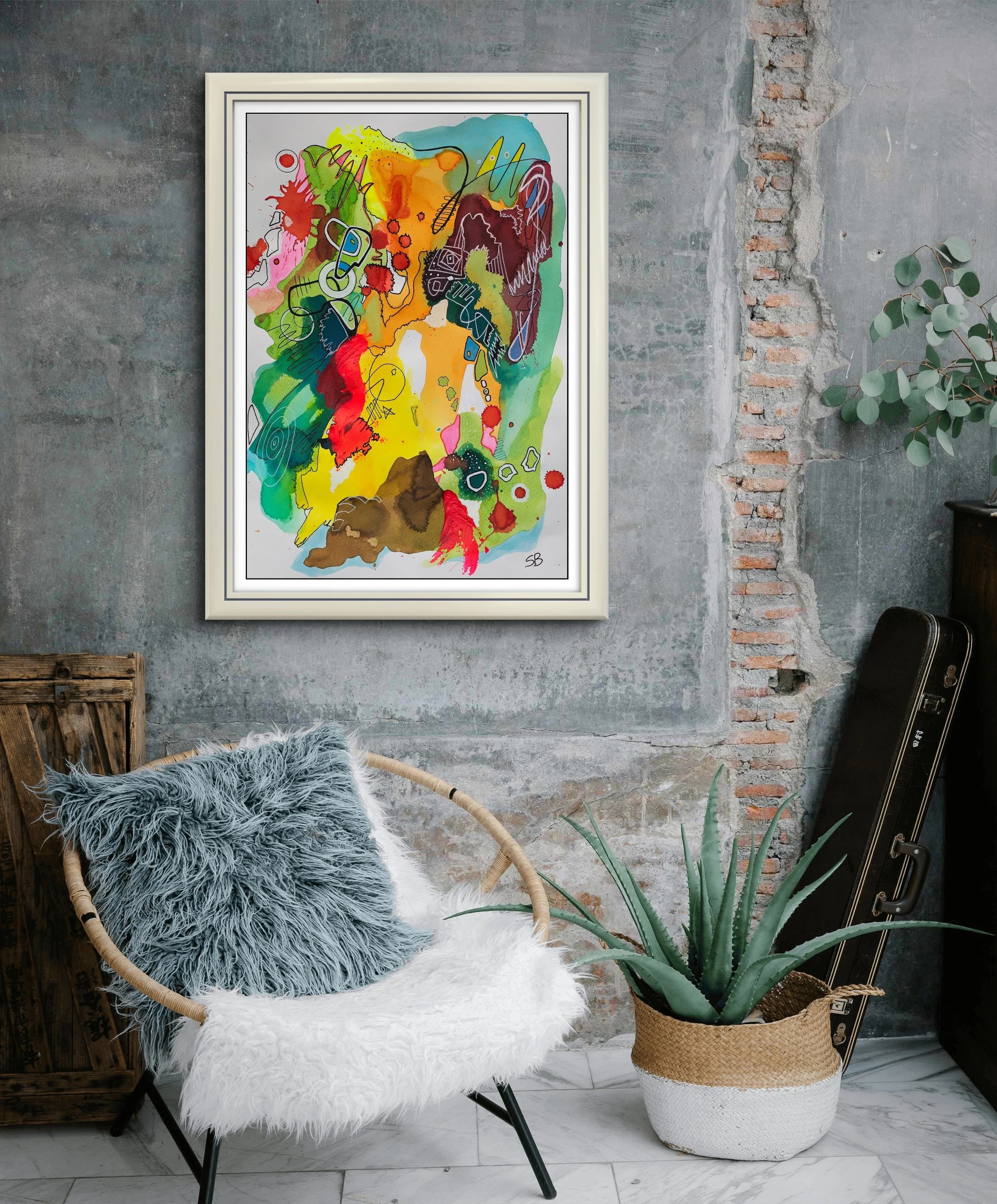 Colorful abstract watercolor painting on a textured gray wall with exposed brick, decorated with a fluffy pillow on a modern chair, a large aloe plant in a woven basket, and a guitar case leaning against the wall.