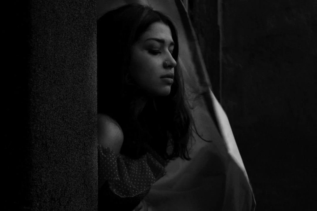 Elegant portrait that uses a subtle blend of light and shadow to emphasize the facial features.