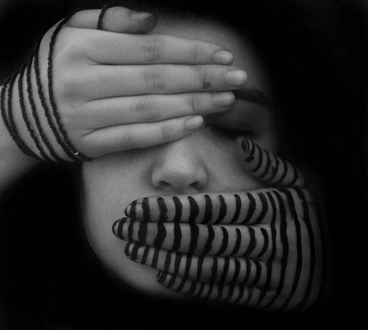 Expressive portrait with an intense gaze and subtle emotions, captured in soft lighting conditions.