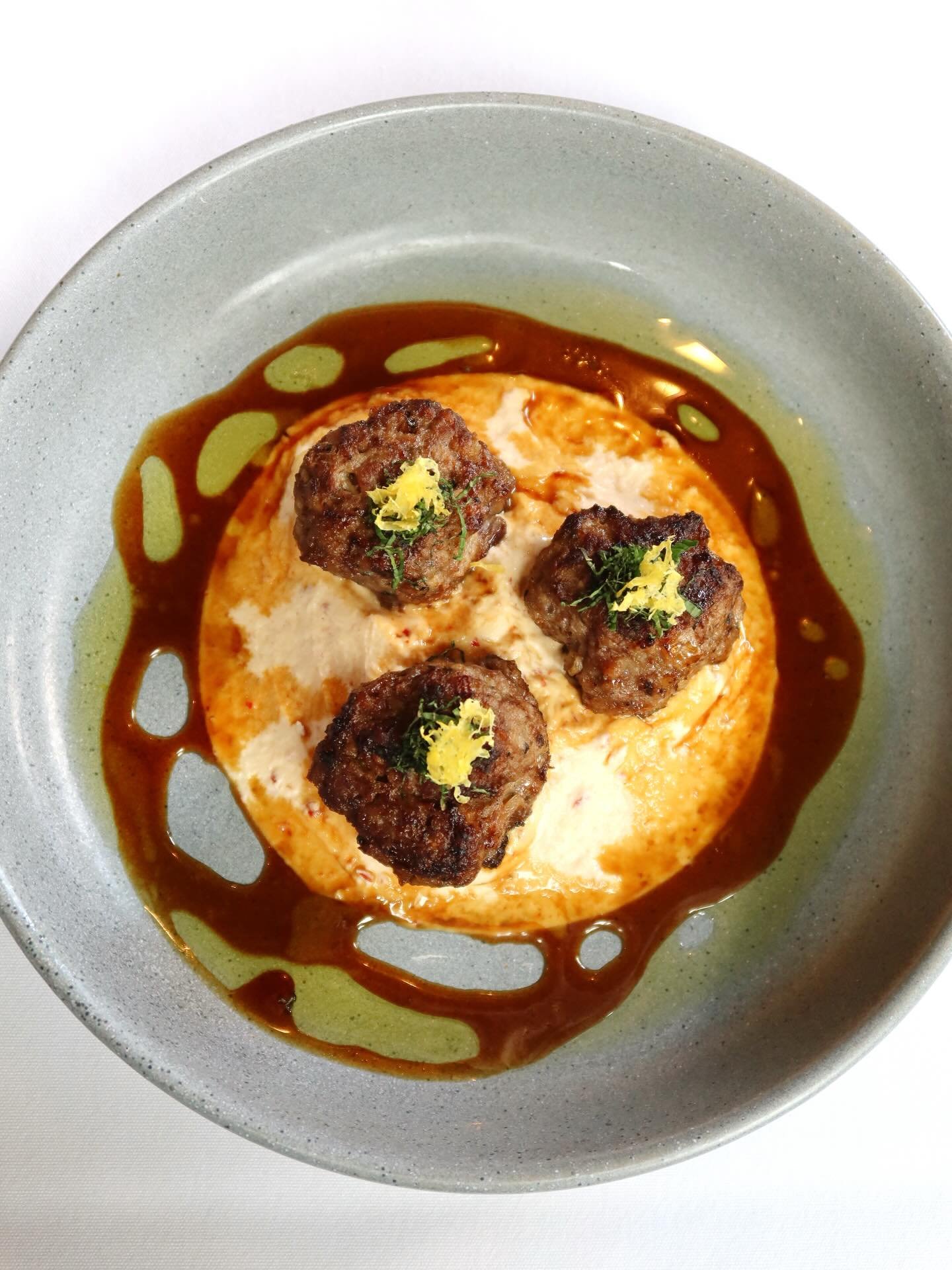 New on the menu ⭐️

Lamb Meatballs layered with harissa-spiced labneh and finished with a pomegranate molasses glaze! 🧆🌿