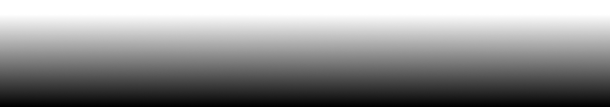 Black and white photograph of an abandoned, partially submerged boat on a rocky shoreline with overcast sky.