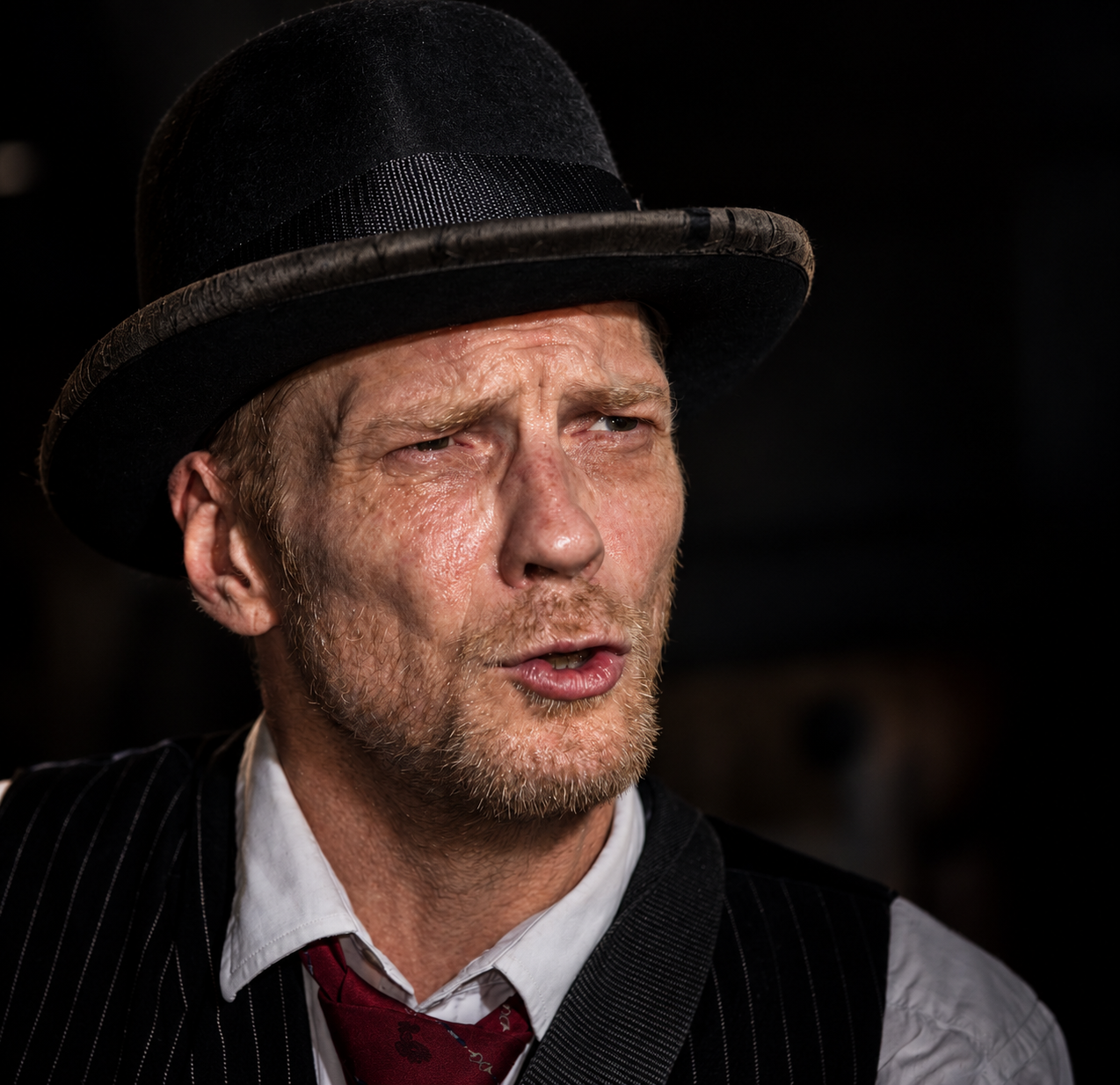 Gary McPherson wearing a black hat and pinstriped waistcoat