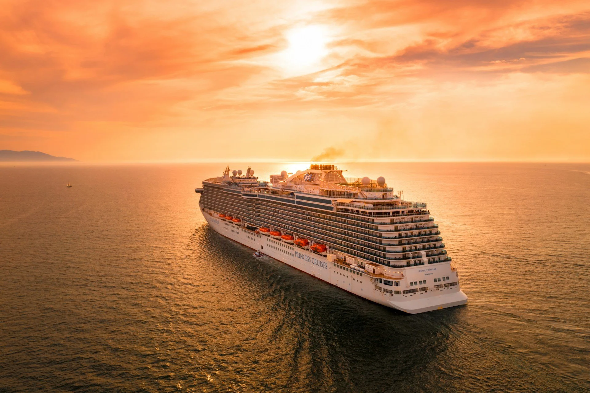 Large cruise ship at sea during sunset, symbolising cruise travel and shore excursions in Scotland