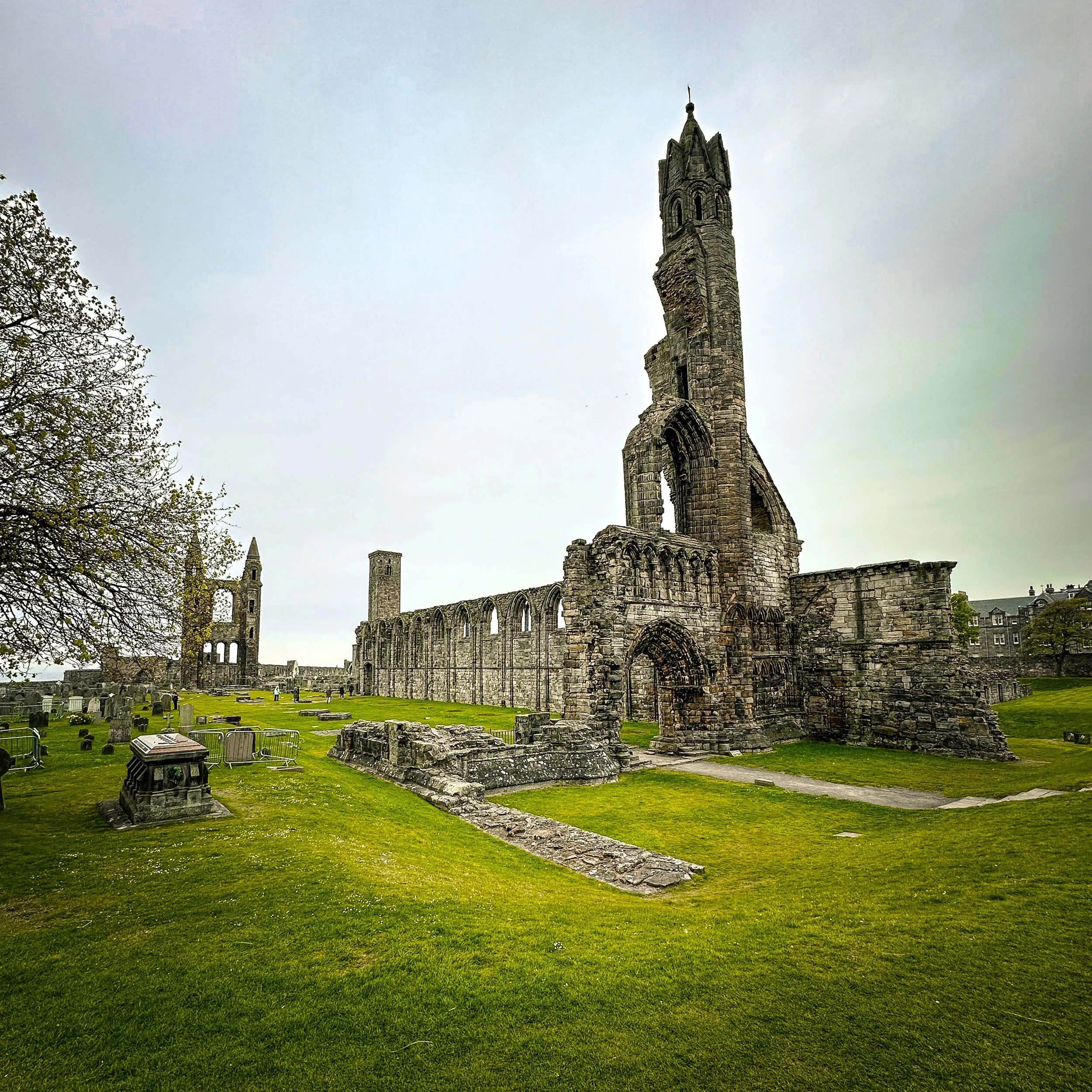 Historic ruins of St Andrews Cathedral in Fife, Scotland, showing the medieval stone towers, cathedral walls and surrounding graveyard.