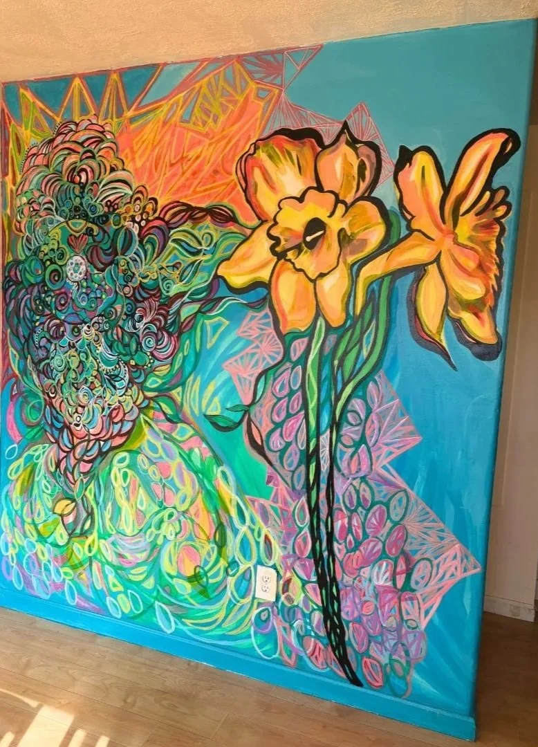 Colorful mural depicting abstract floral design with large yellow flowers and green leaves on a vibrant background.