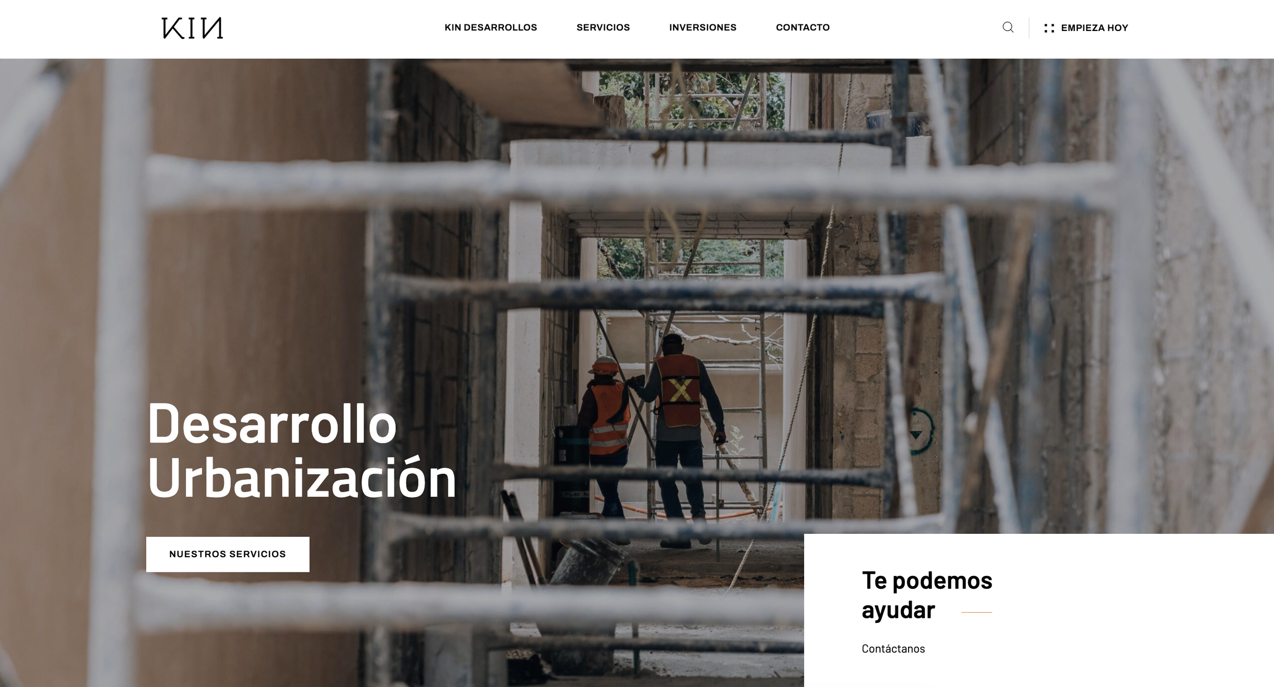 Workers wearing safety vests and helmets working on a construction site, seen through scaffoldings. Web design 