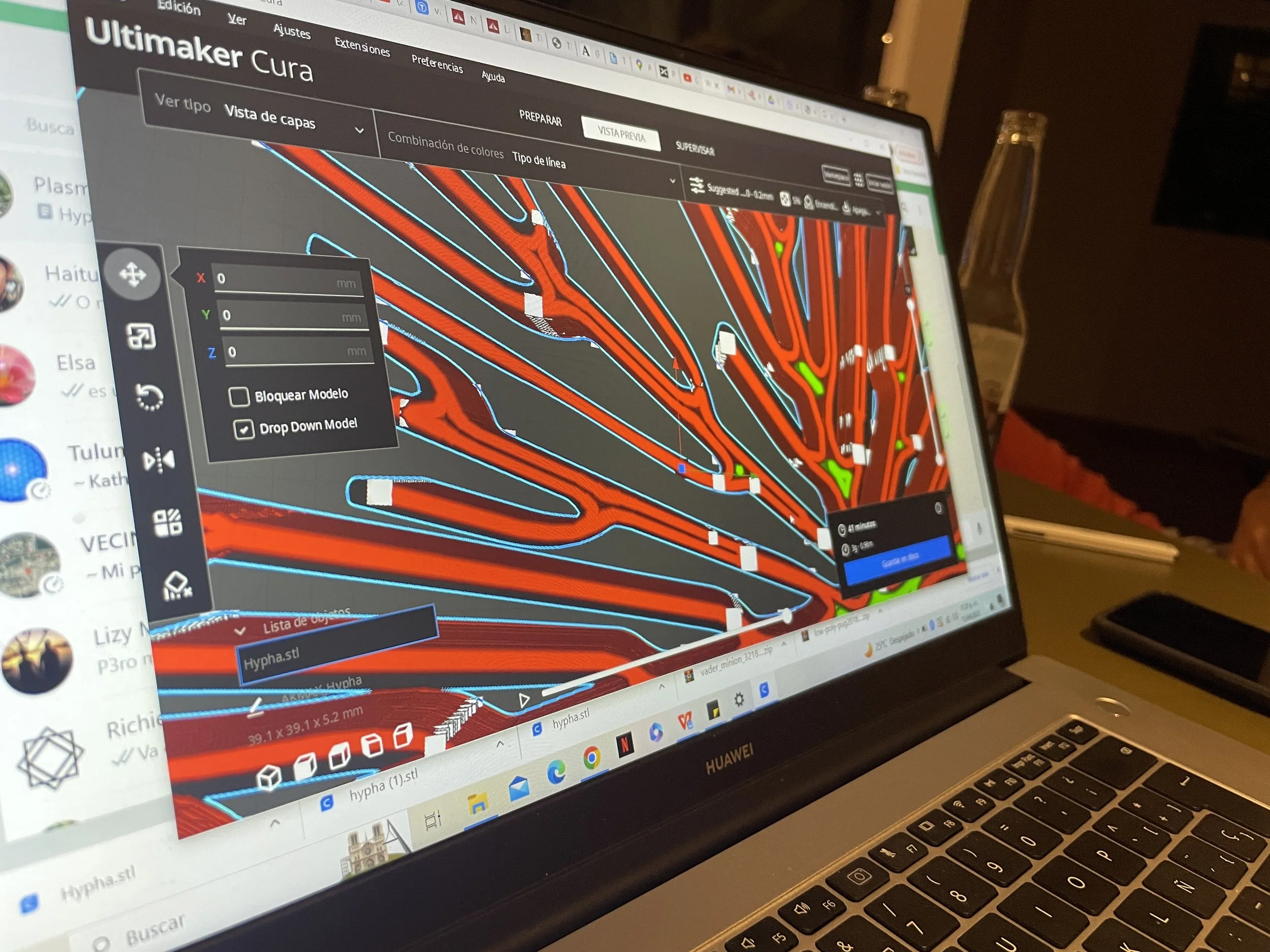 Laptop displaying 3D modeling software called Ultimaker Cura with a complex 3D print design in red and blue lines, alongside various tools and settings on the screen. Hypha Inc Marketing Agency and Creative Studio Lab, Tulum.