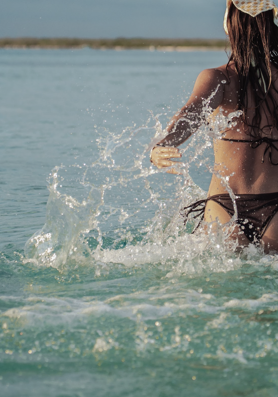 Walking through shallow turquoise waters at El Cielo.