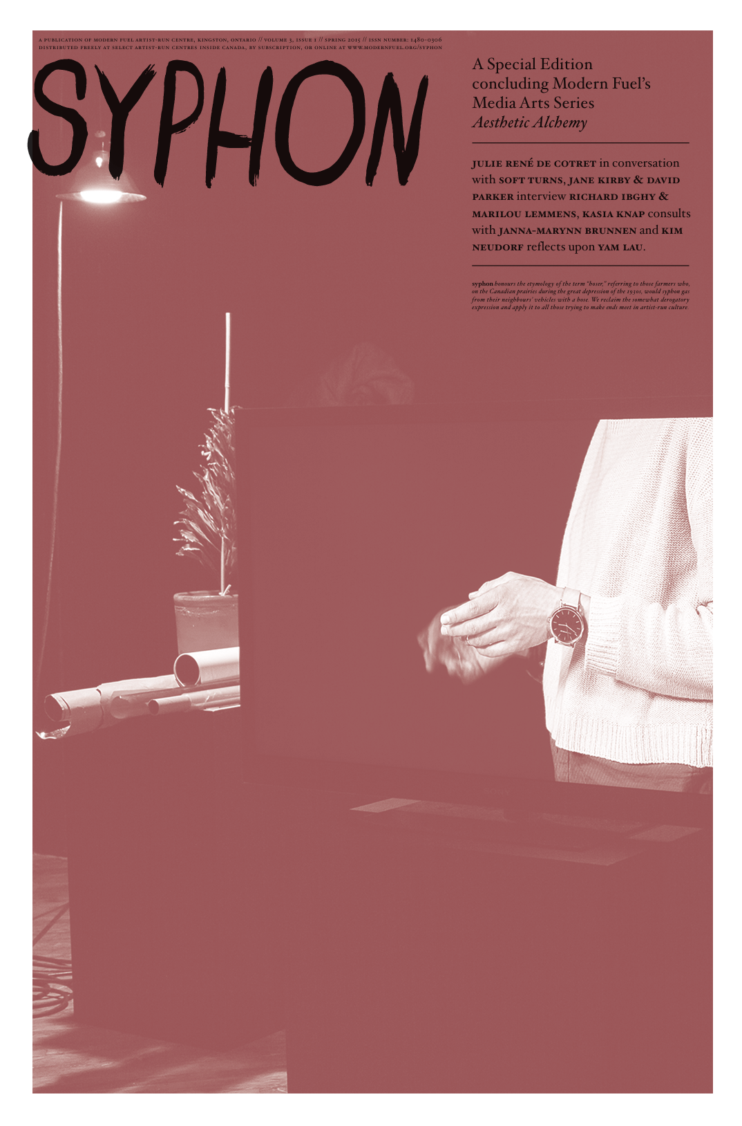 Cover of Syphon magazine featuring a large title at the top, a person wearing a watch partially visible on the right, standing in front of a black box, with a background including a potted plant and rolled papers. The magazine has a pinkish-red background with black and red text highlighting articles and contributors.