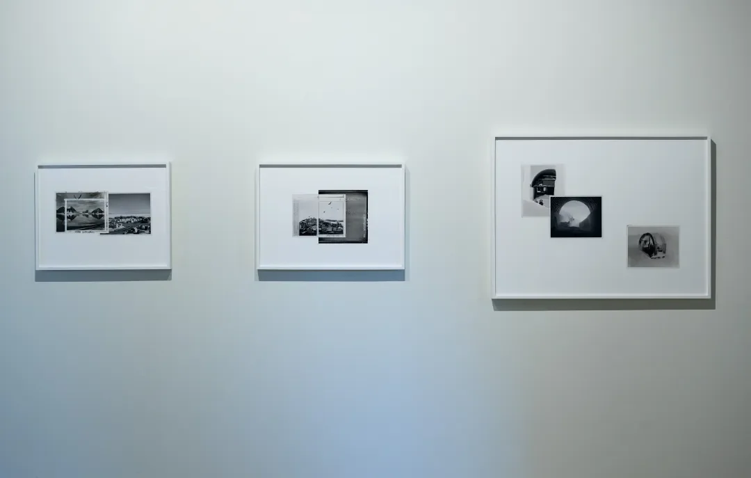 Three framed black-and-white photographic art pieces hanging on a plain white gallery wall.