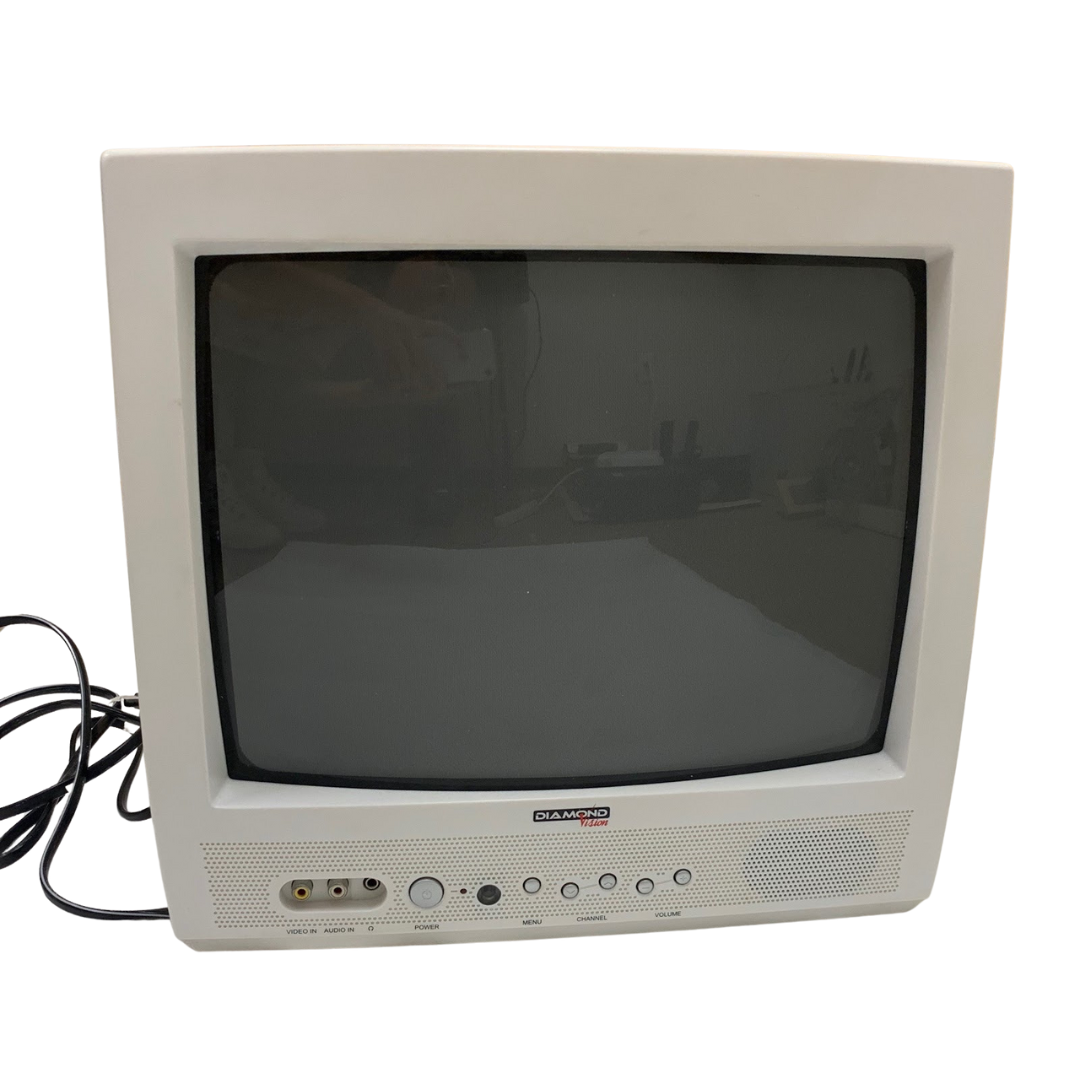 An old CRT television in white casing with a curved screen, RCA input ports, and control buttons on the front.